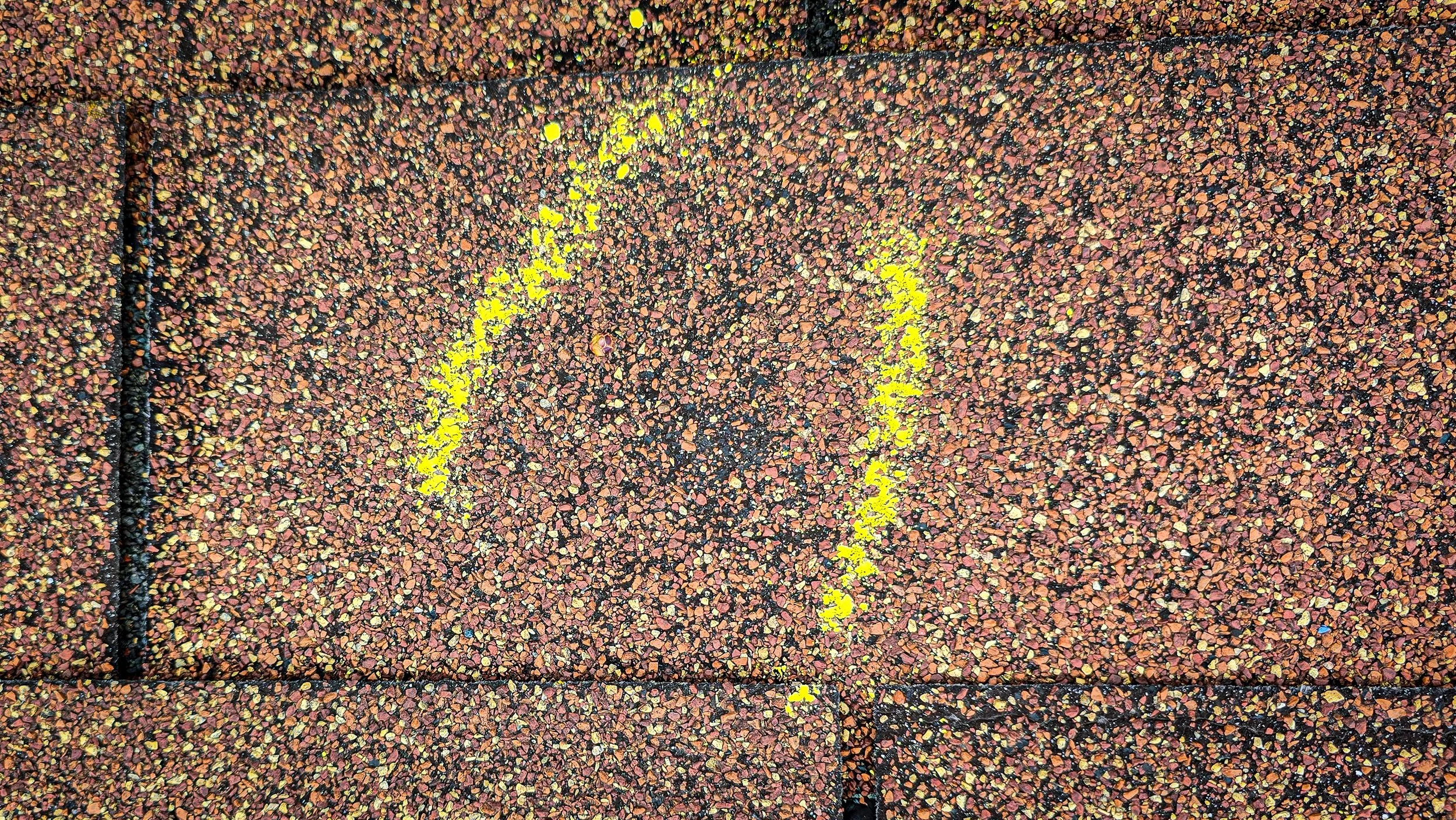 Hail impact. Hail damage. Hail to the roof. Hail damage to shingles.