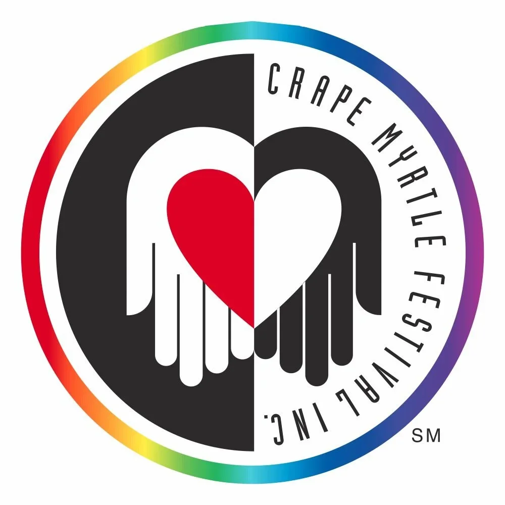 A circular logo with a rainbow-colored border featuring a black and white hand with a red and white heart between the palms. The text 'Crape Myrtle Flushes' encircles the hand design.