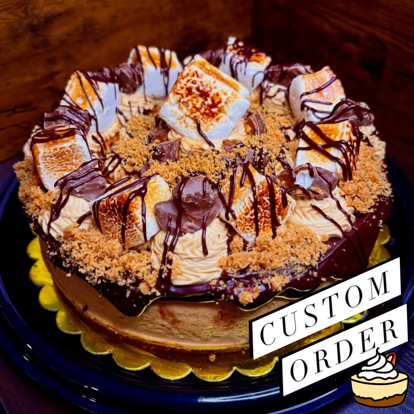 If the minis weren&rsquo;t enough to satiate your sweet tooth, feast your eyes on the completed custom order full size S&rsquo;mores Cheesecake! Coming in at our fourth ever full size cheesecake we&rsquo;ve ever made, I think I&rsquo;m starting to ge