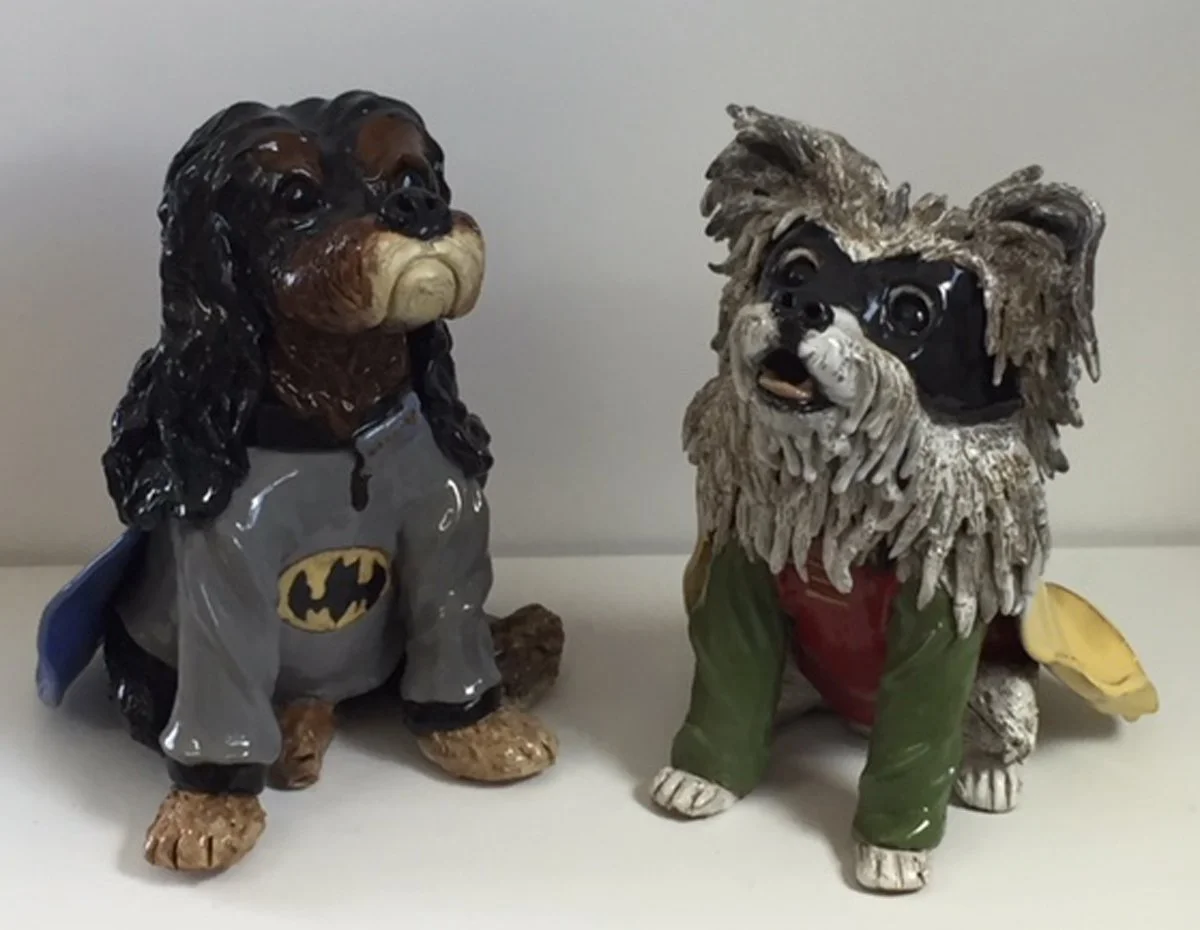 Sculpture of two dogs dressed as Batman and Robin for Halloween