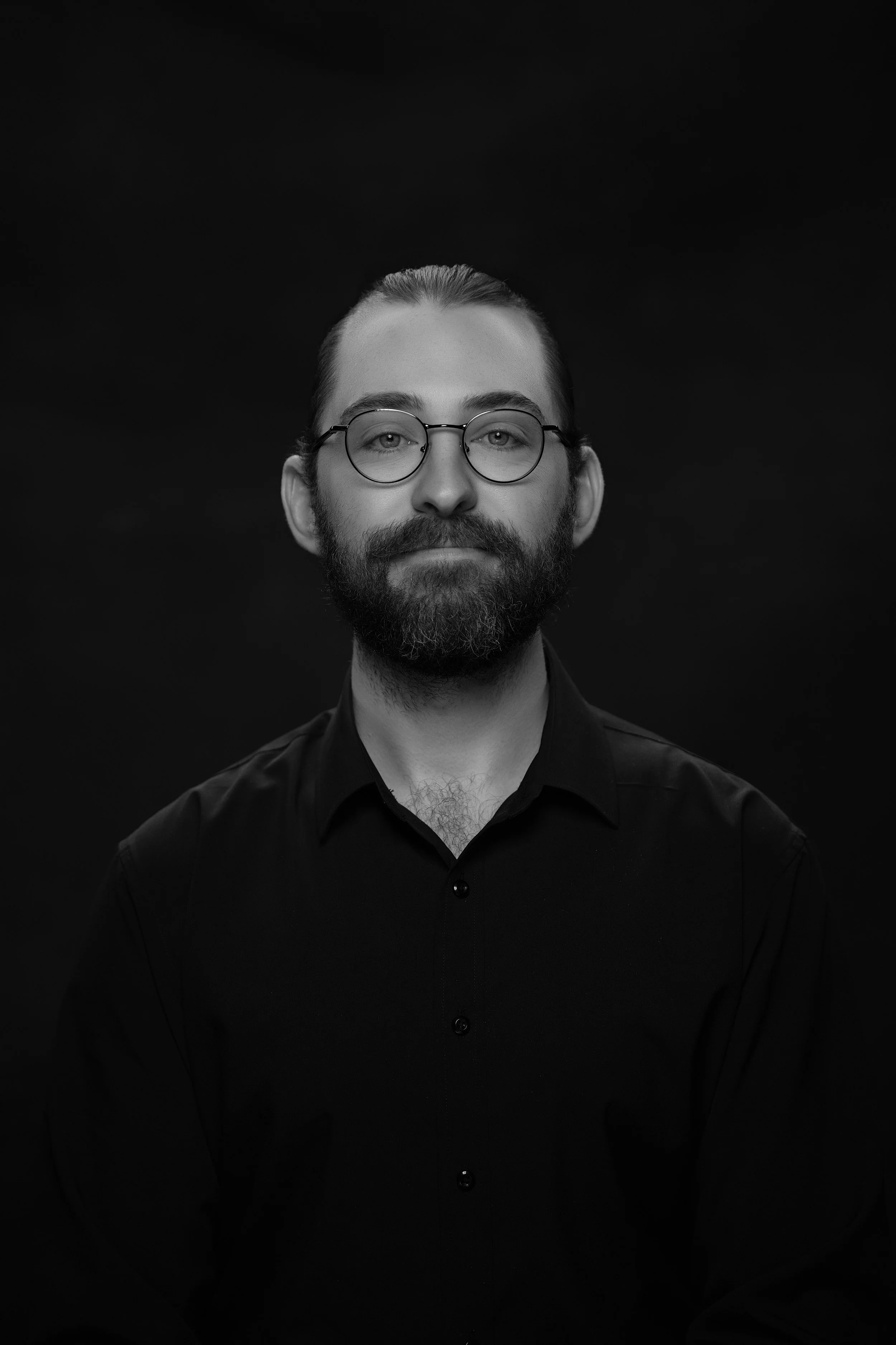 Jake Zabinski operating a movie camera outdoors near a tree and a fence.