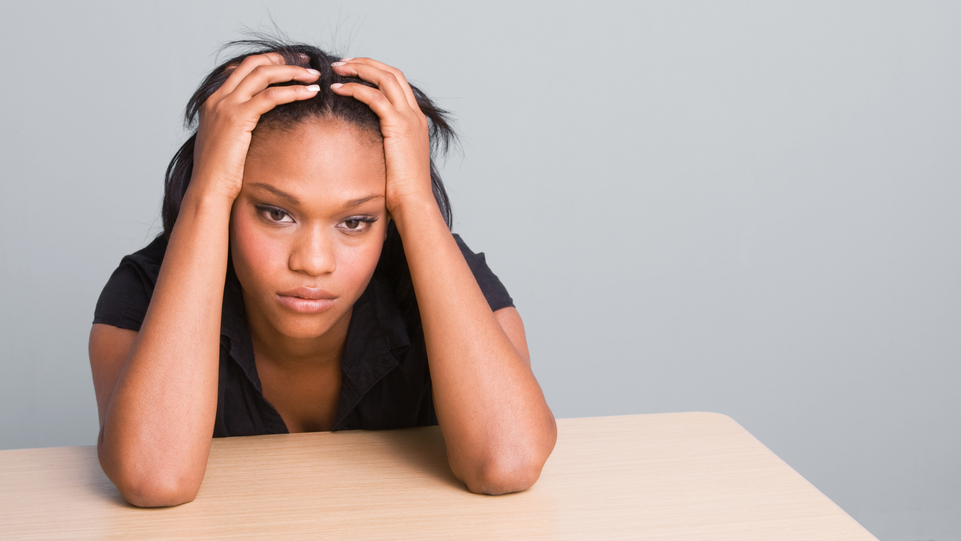 a person looking overwhelmed at a dining table.