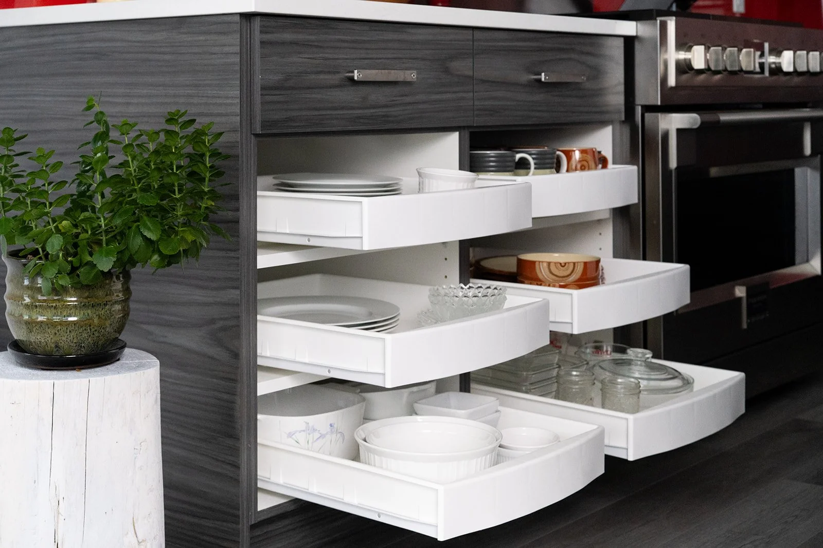 Stacked rollout drawers providing accessible cabinet storage for dishes