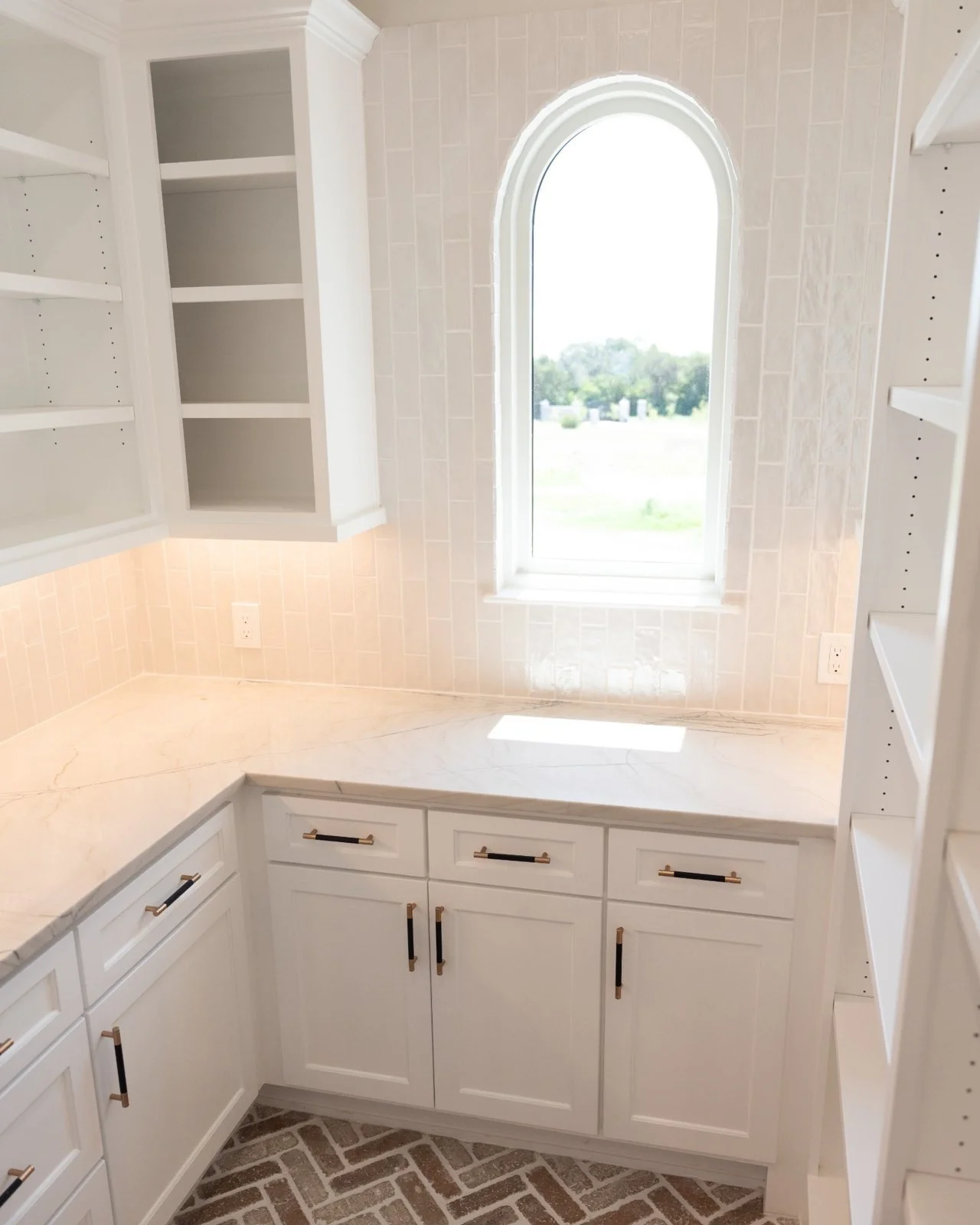 Open concept kitchen and living room remodel with natural quartzite countertops by Atria Design + Build.