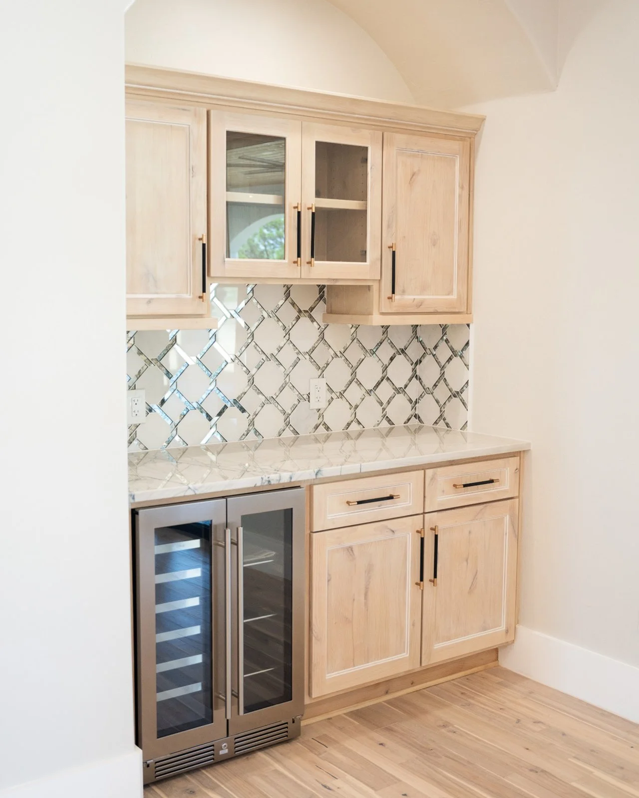 Custom knotty alder cabinetry with built-in minibar and wine fridge in The Takeover project