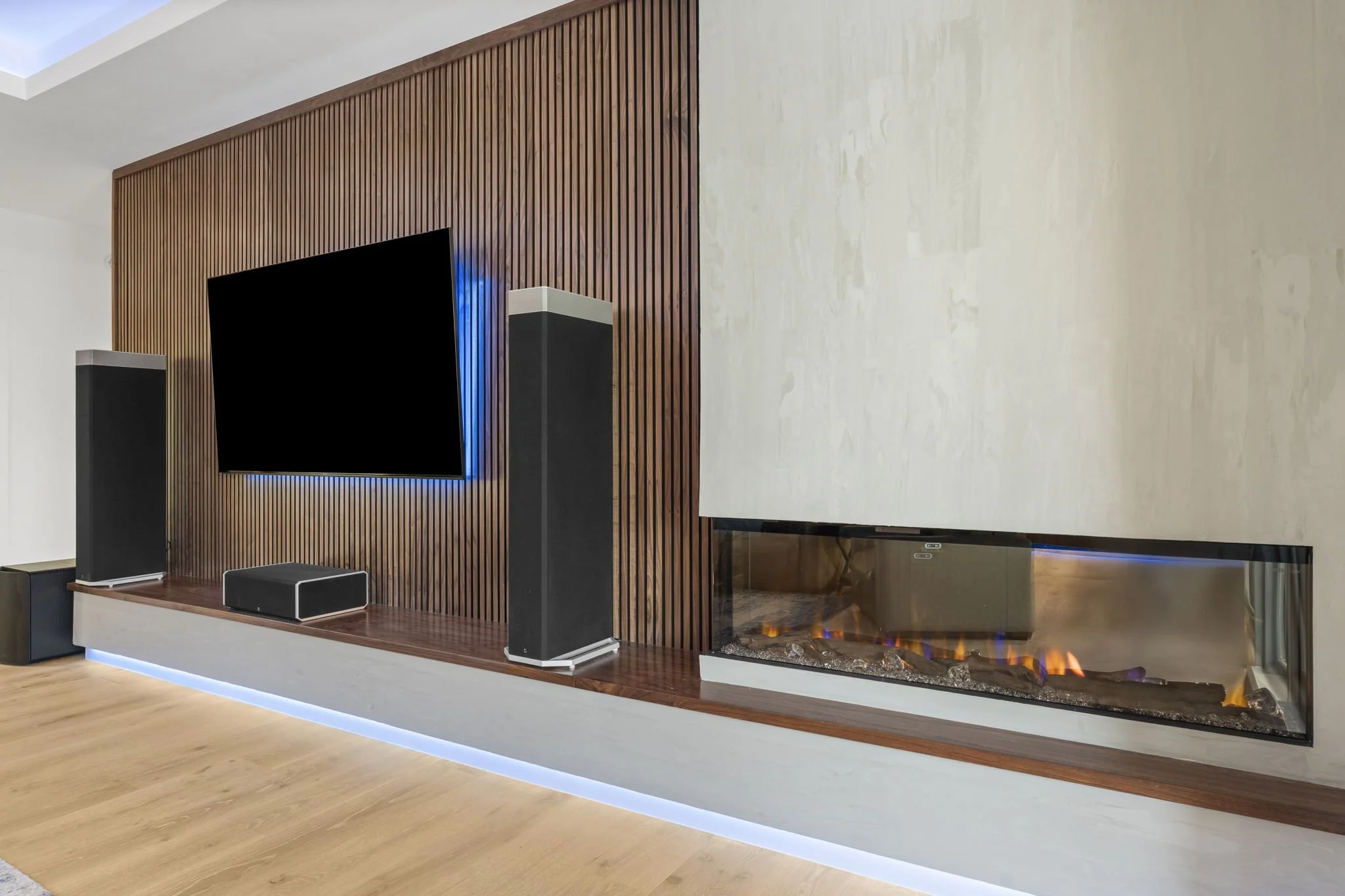 Living room with wood-paneled fireplace and smooth-grain cabinetry in the Madrone Remodel project.