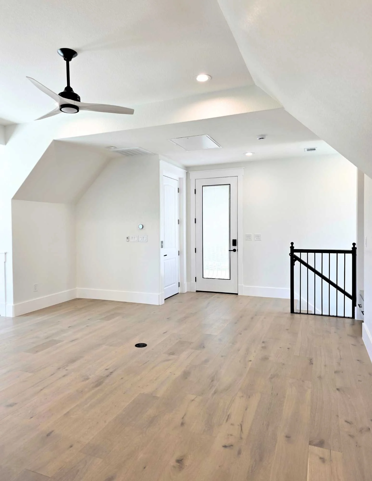 Casita living area with balcony, elevator, and garage access.  Hardwood floors