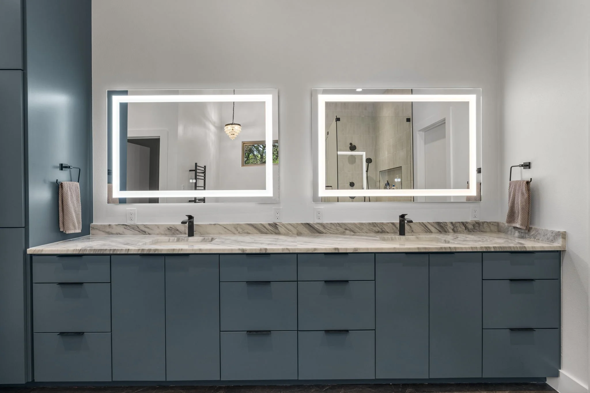 Custom bathroom remodel featuring Brazilian Carrara marble and sleek modern finishes.