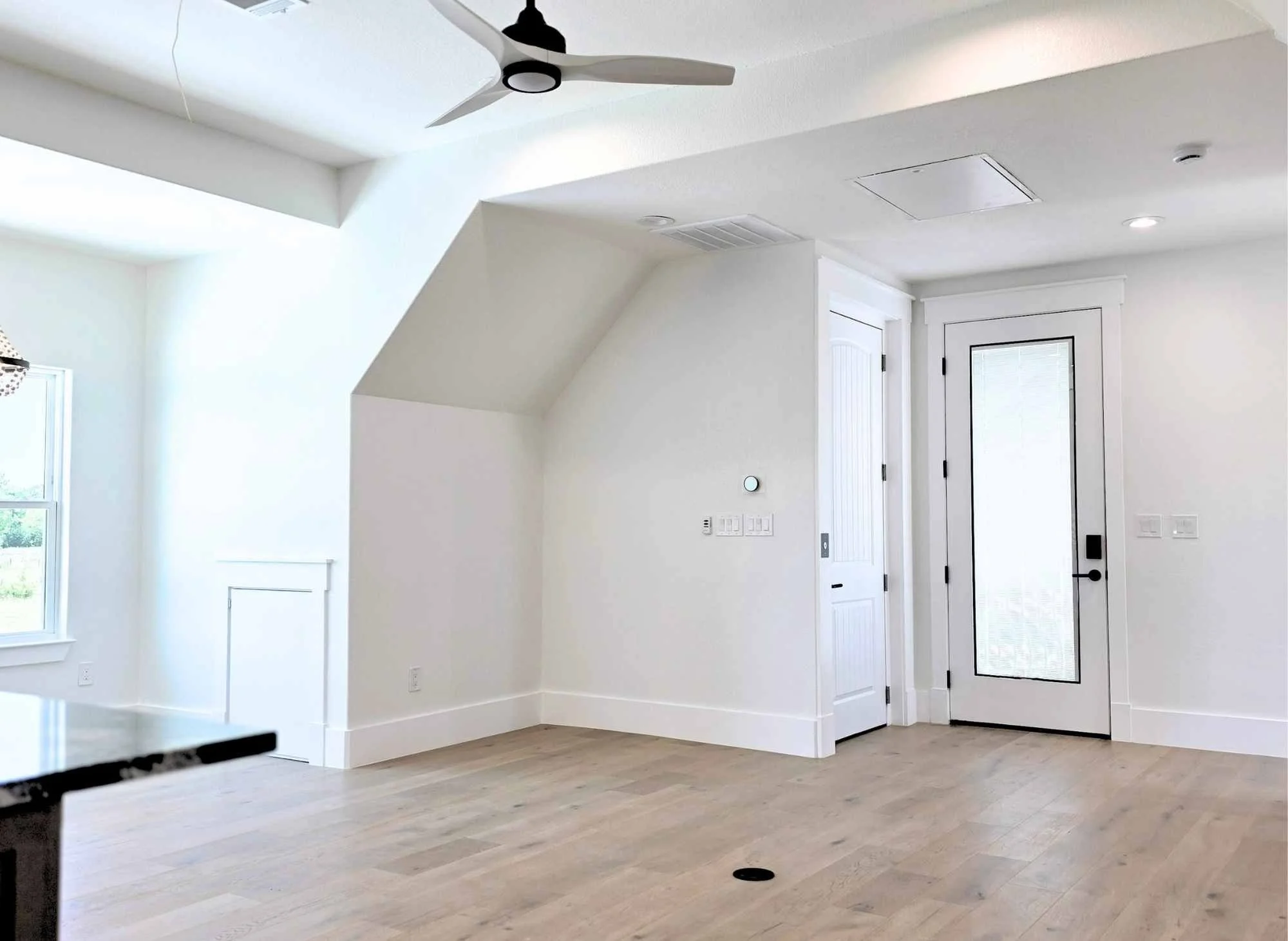 Casita living area with balcony, elevator, and garage access.  Hardwood floors
