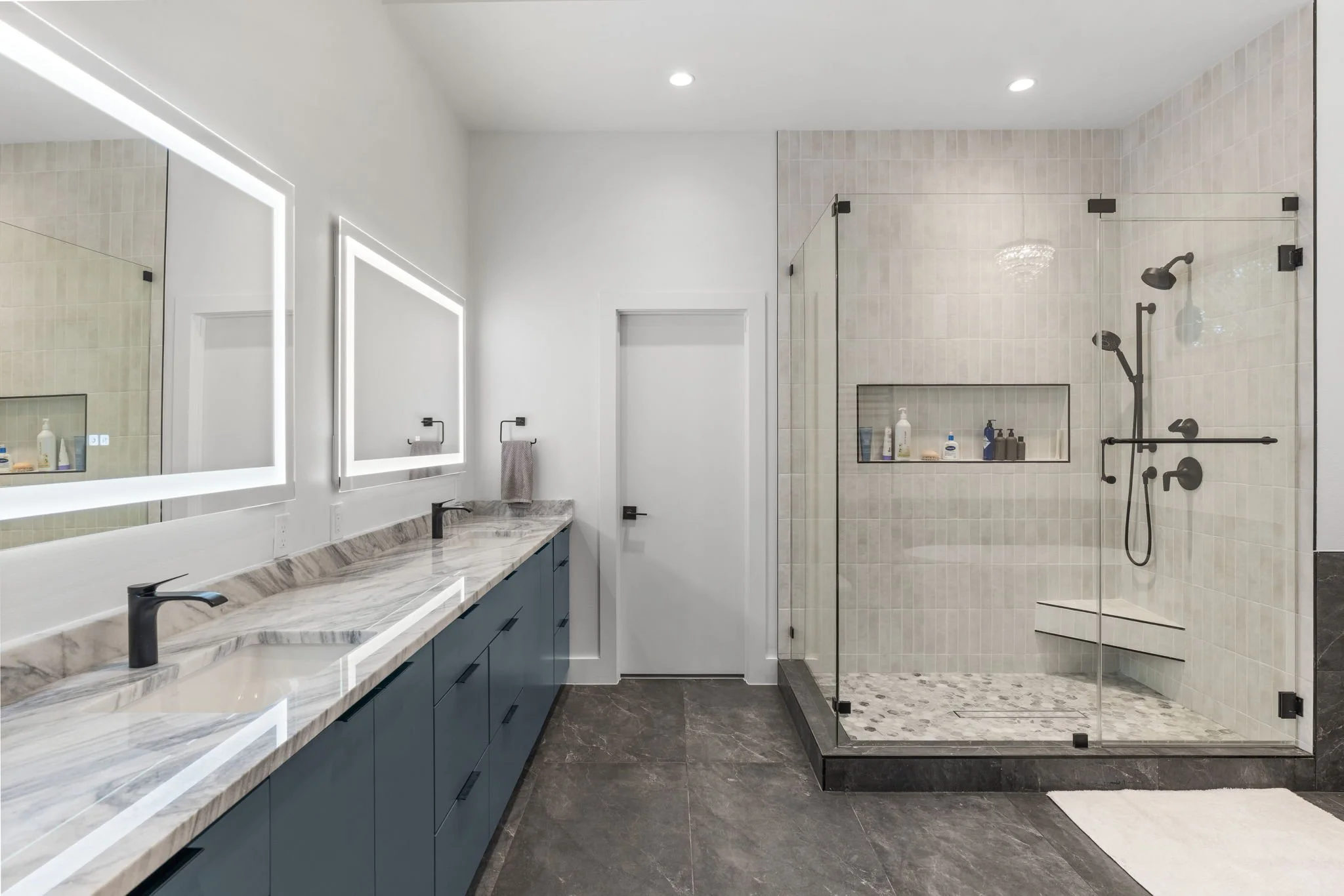 Custom bathroom remodel featuring Brazilian Carrara marble and sleek modern finishes.