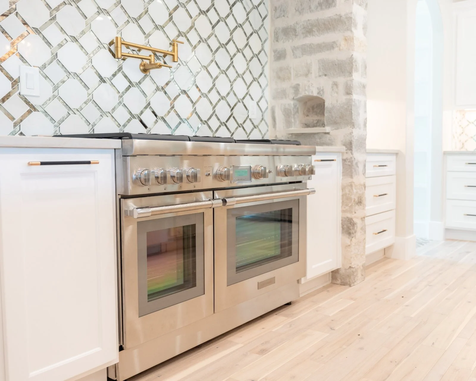 Open concept kitchen and living room remodel with natural quartzite countertops by Atria Design + Build.