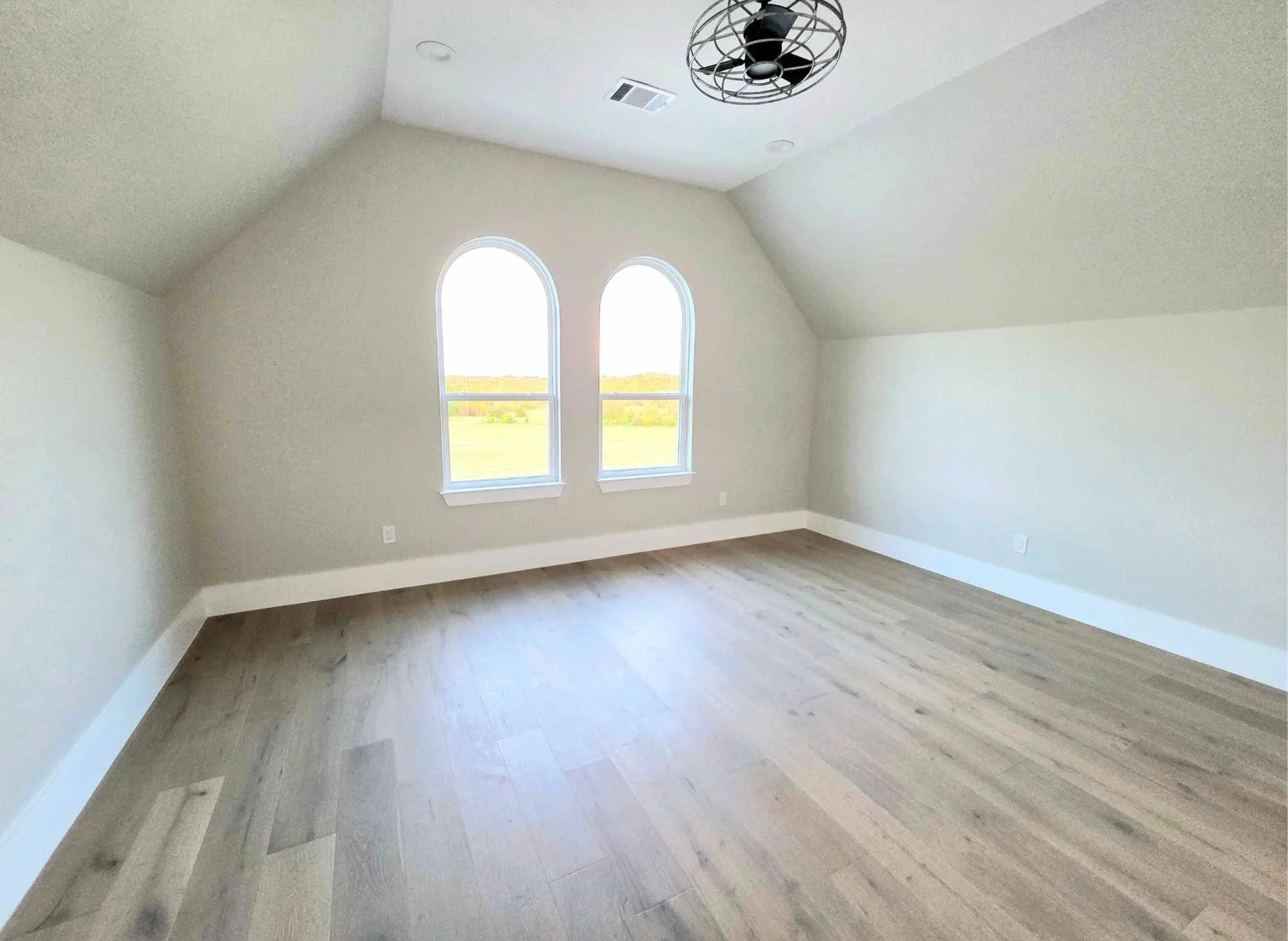 Main bedroom inside casita with hardwood floors, closet and fan