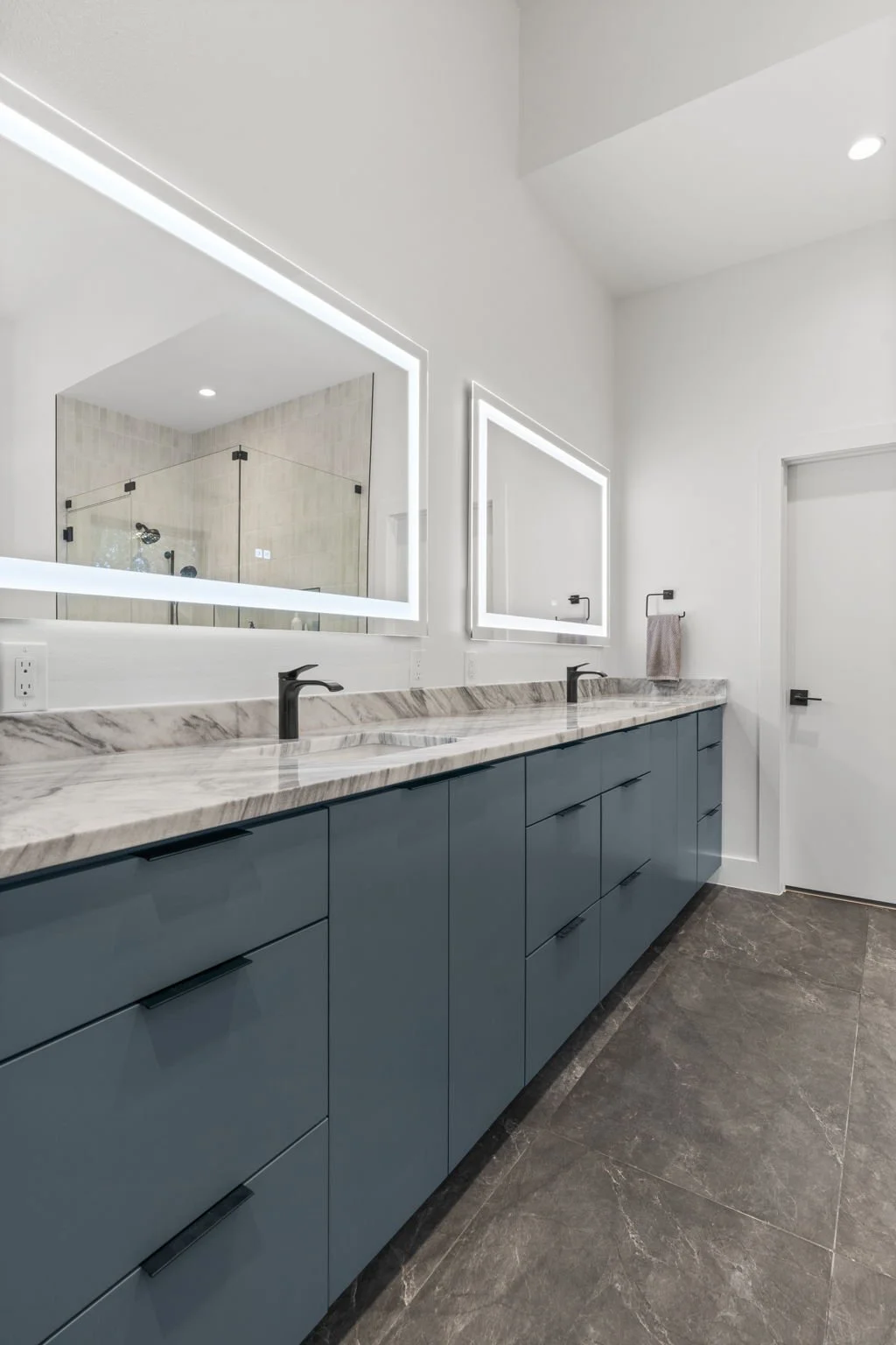 Custom bathroom remodel featuring Brazilian Carrara marble and sleek modern finishes.