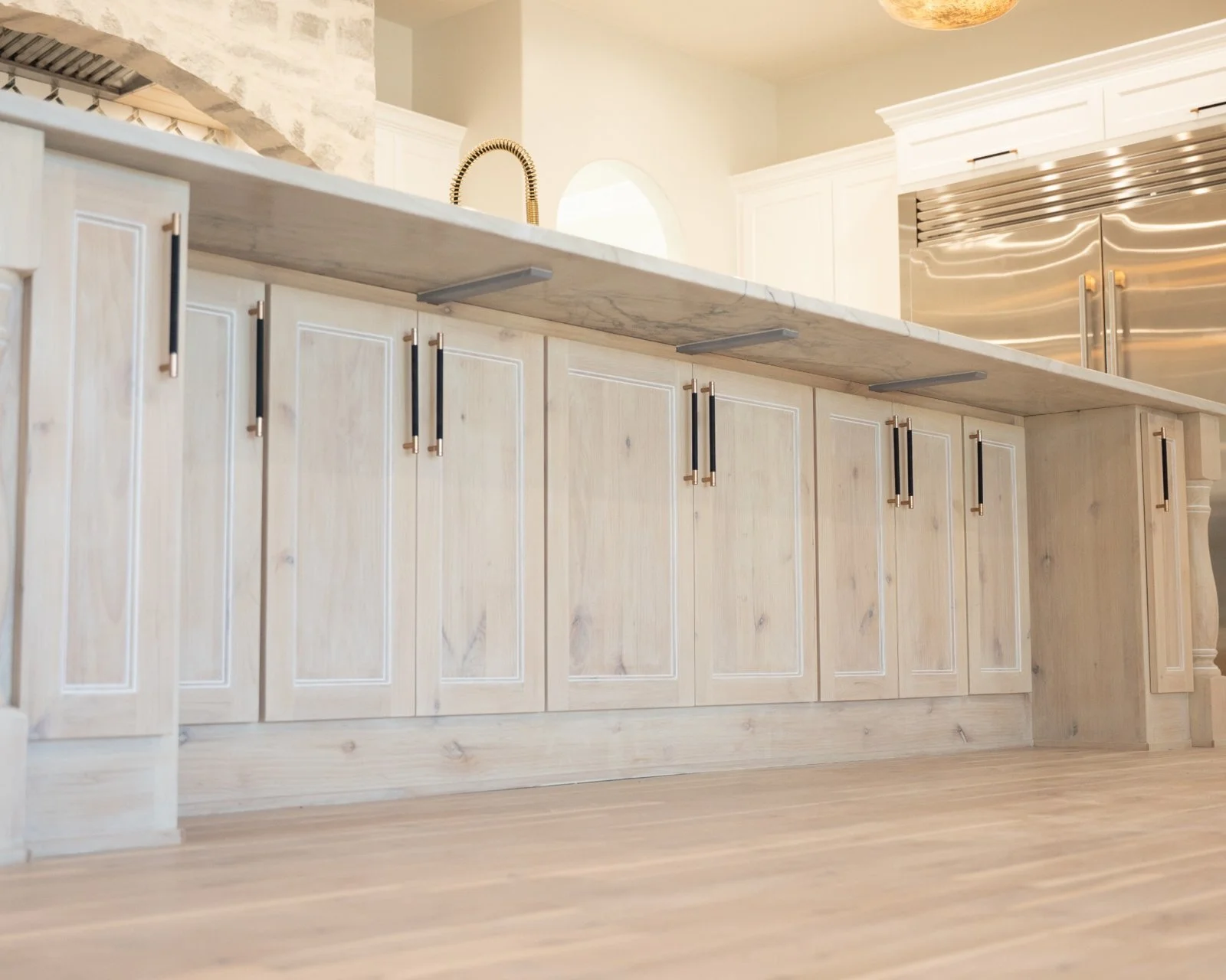 Open concept kitchen and living room remodel with natural quartzite countertops by Atria Design + Build.