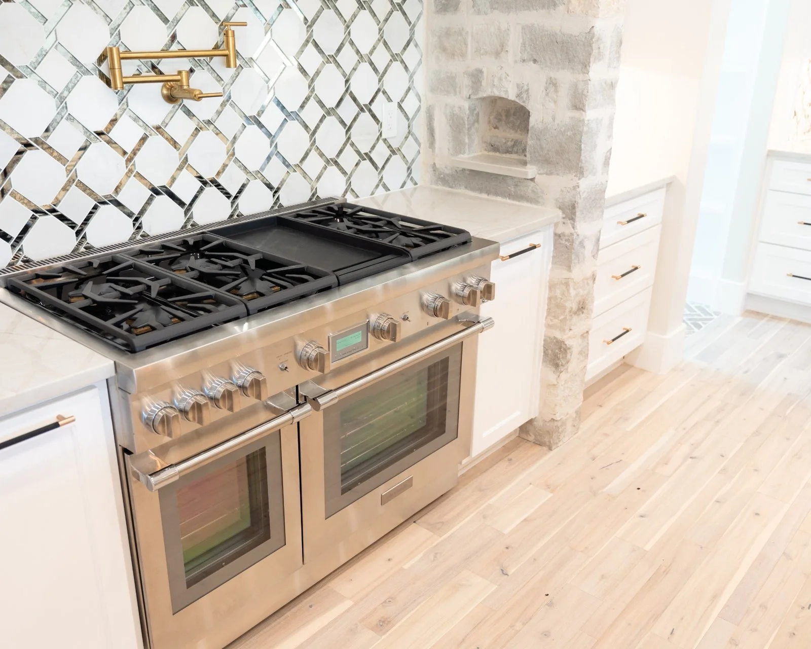 Open concept kitchen and living room remodel with natural quartzite countertops by Atria Design + Build.