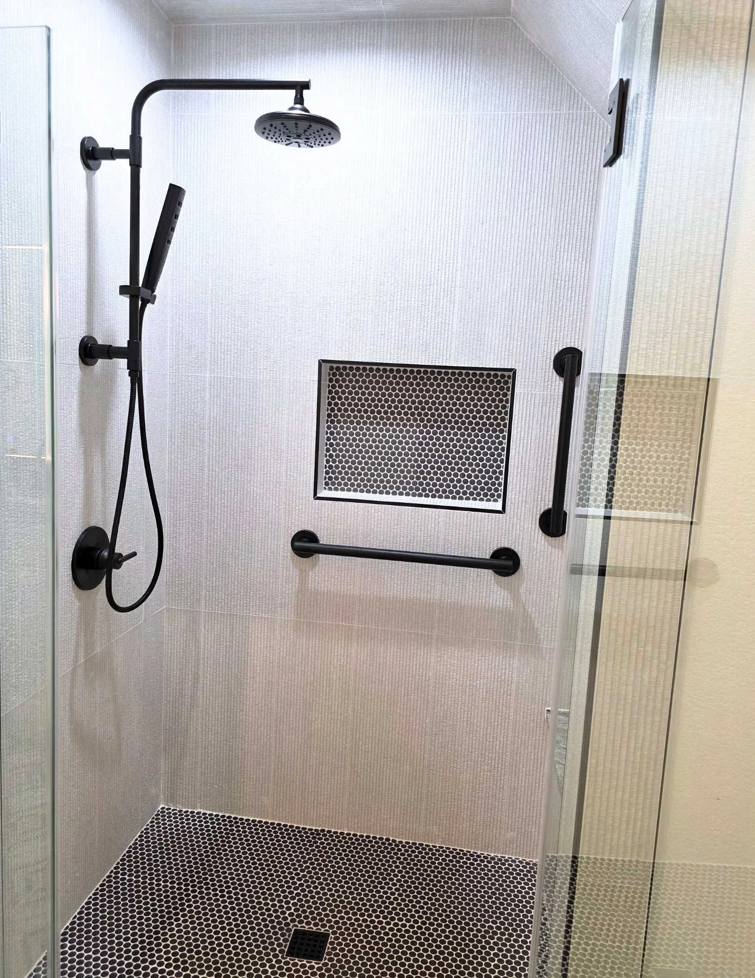 Casita shower with hand rails, tile, and grab bars. 