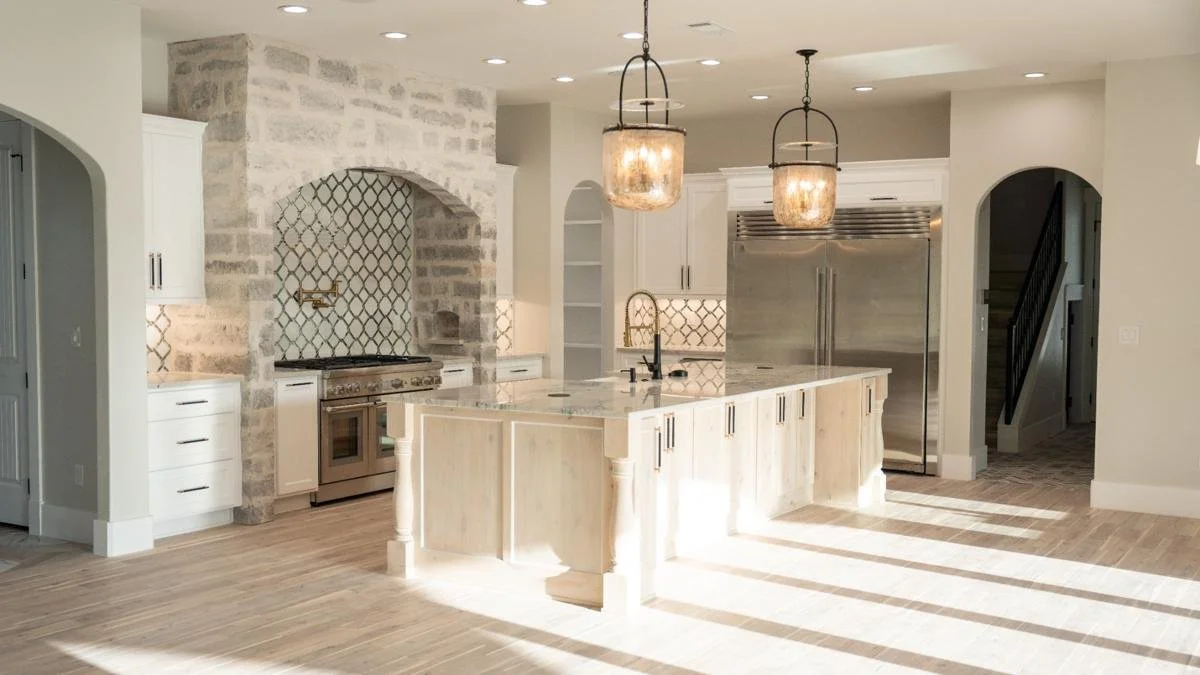 Open concept kitchen and living room remodel with natural quartzite countertops by Atria Design + Build.