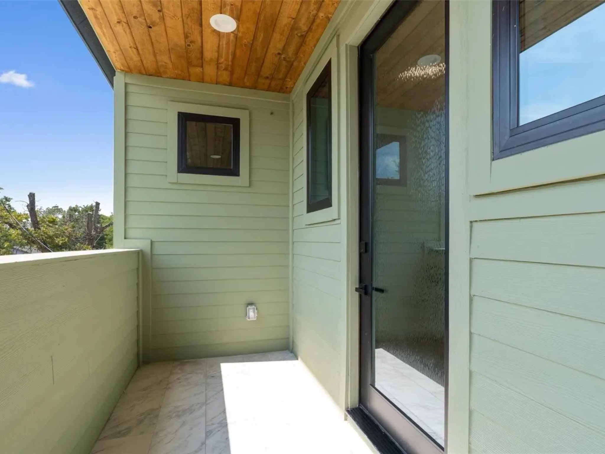 Downtown Austin custom home exterior balcony by Atria Design and Build.