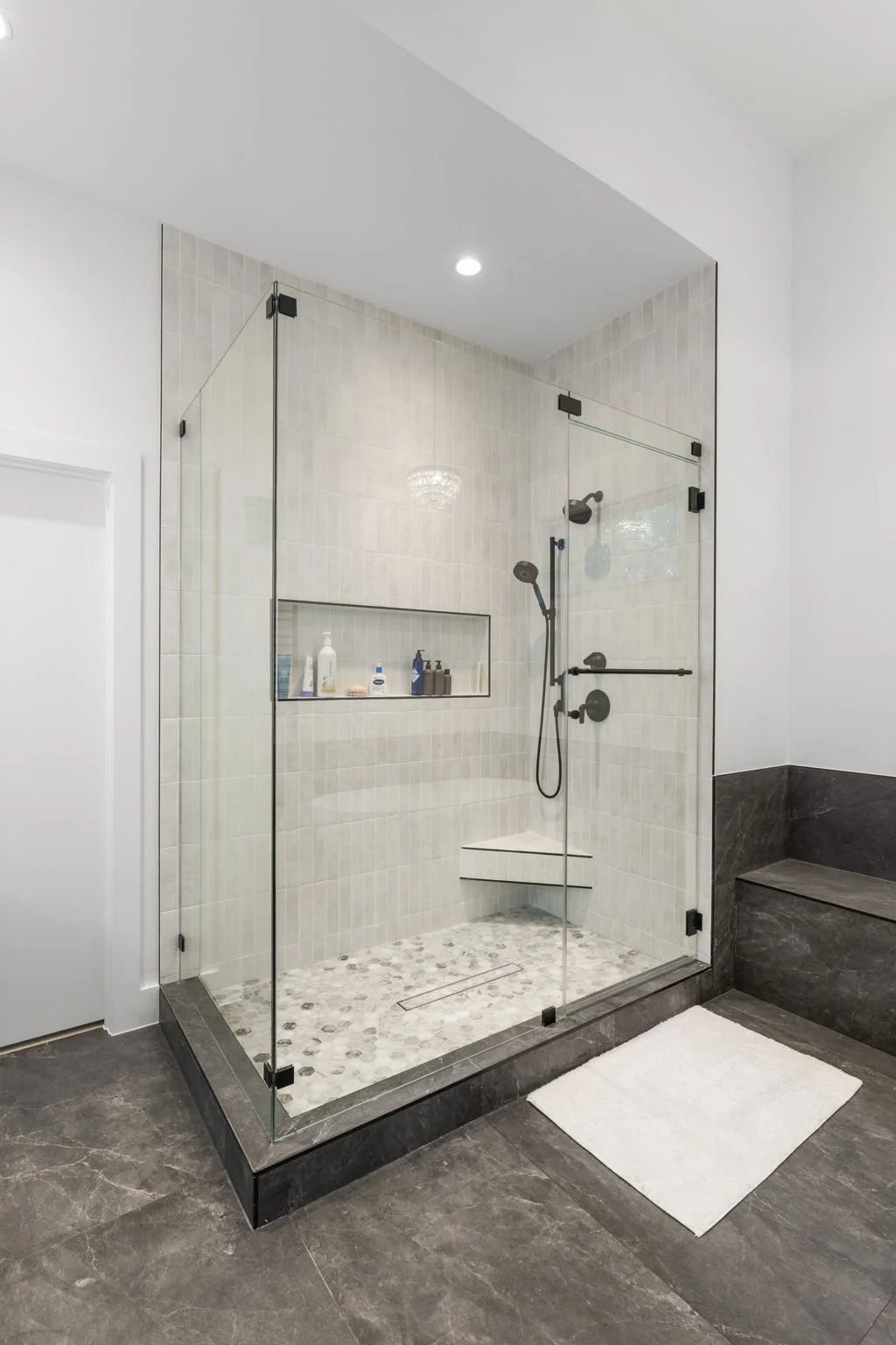 Custom bathroom remodel featuring Brazilian Carrara marble and sleek modern finishes.