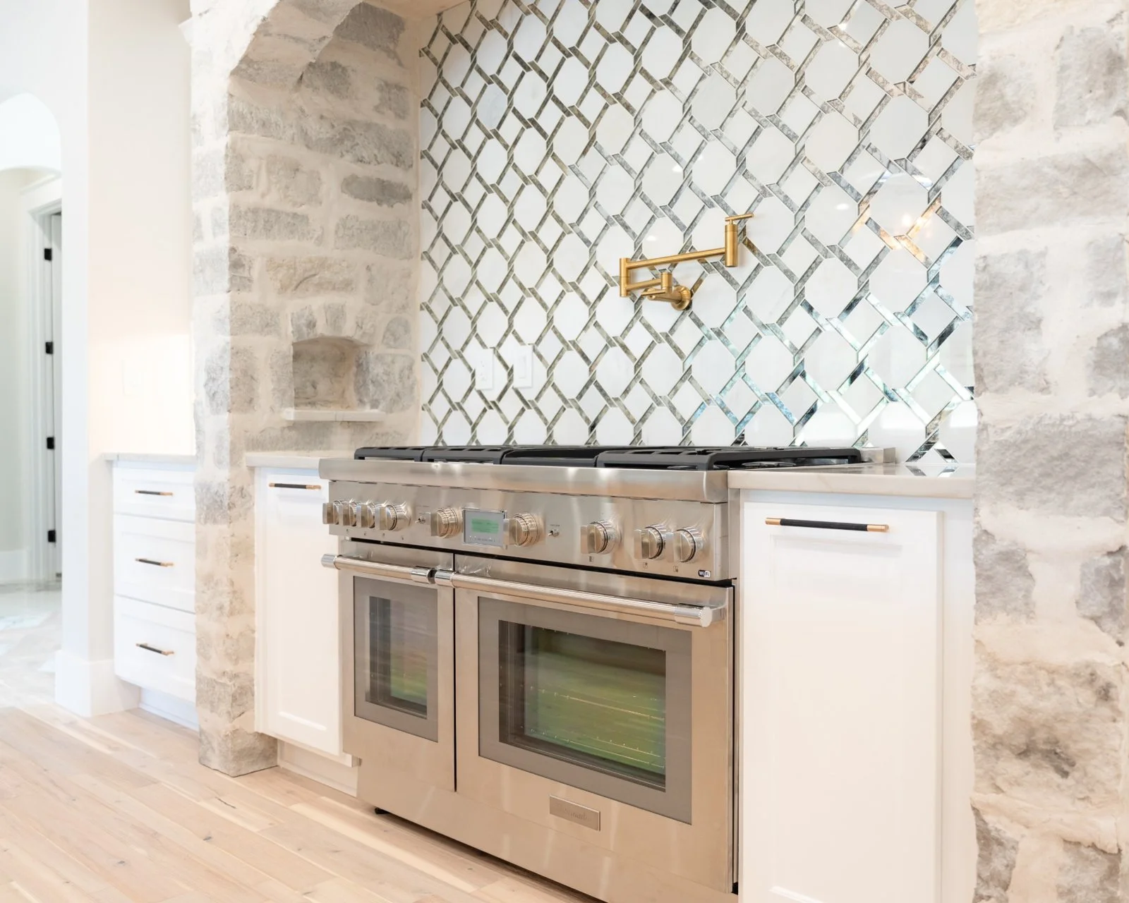 Open concept kitchen and living room remodel with natural quartzite countertops by Atria Design + Build.
