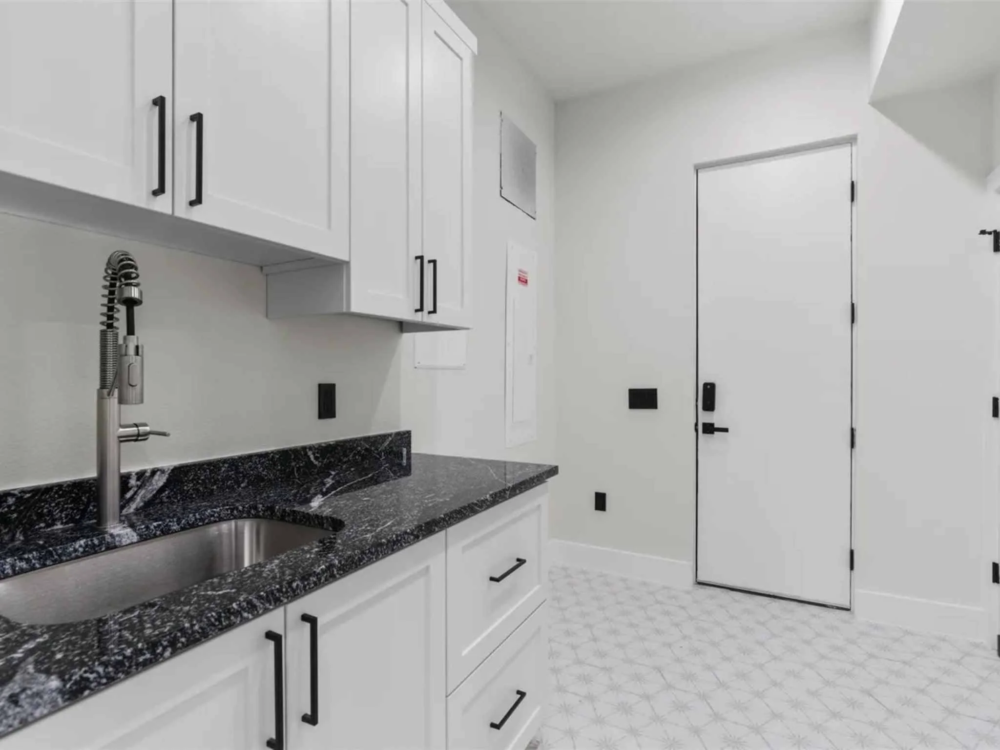 Large laundry room in a downtown Austin custom home by Atria Design and Build.