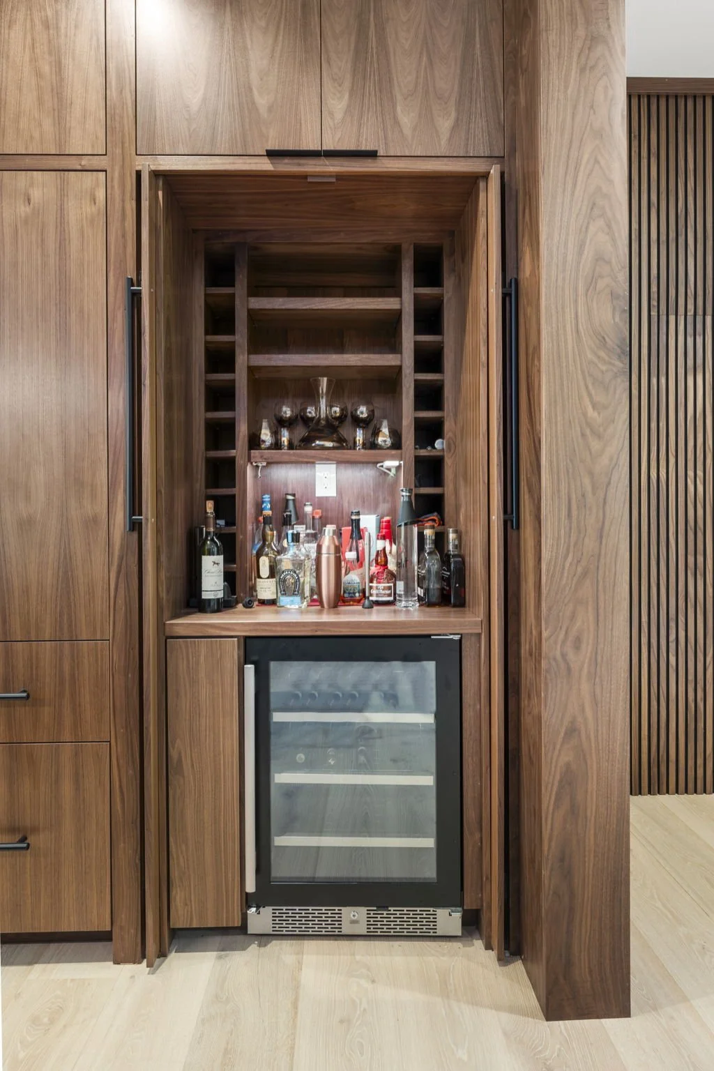 Modern kitchen remodel in Central Texas with walnut cabinetry and quartzite countertops by Atria Design + Build.