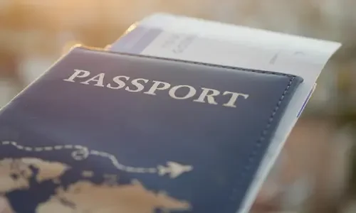 Close-up of a passport with travel documents tucked inside, representing personalized, custom-curated itineraries.