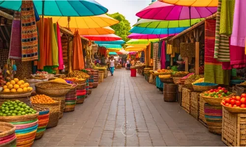 Colorful open-air market with vibrant textiles, baskets, and fresh produce, featured in a travel tip by Travel With Sabeen.