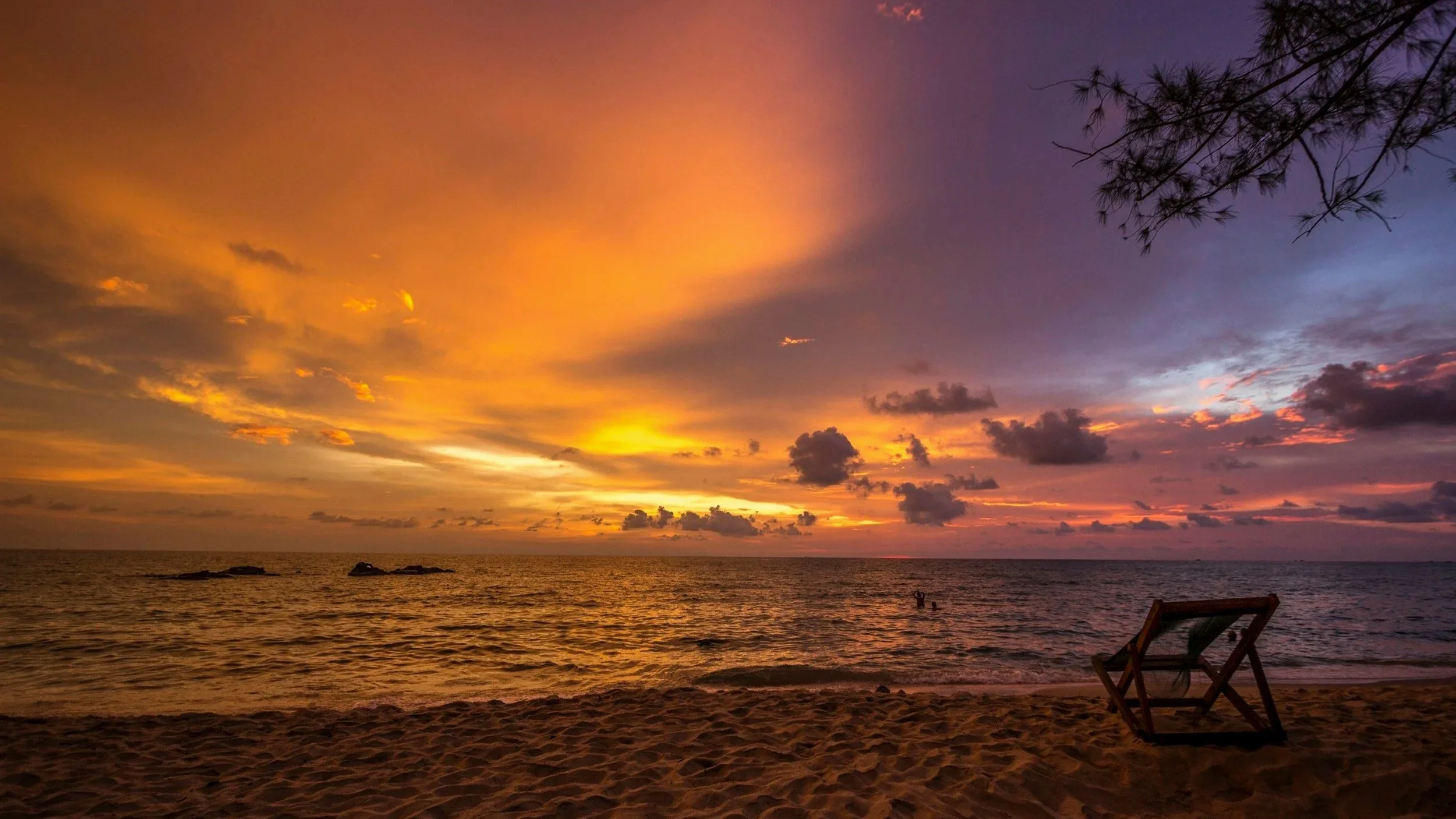 Sunset over the ocean with colorful sky and reflecting water.