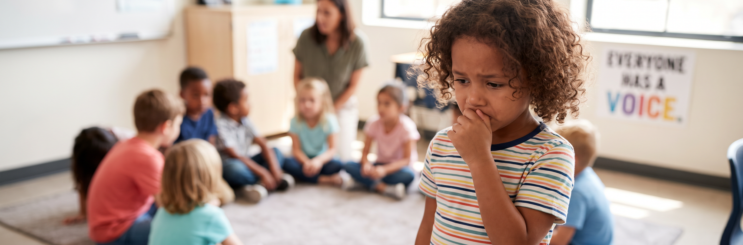 Child with speech anxiety or selective mutism in classroom setting with supportive environment poster
