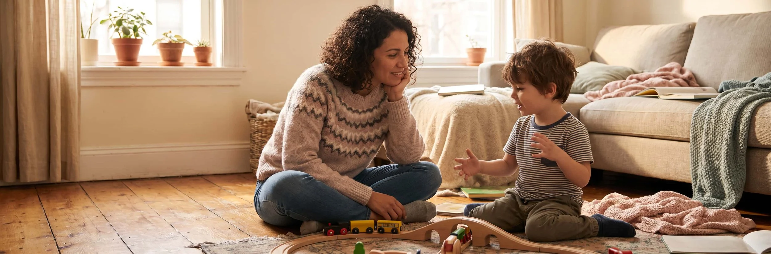 Round Rock parent listening patiently as her young child talks during play, part of stuttering therapy at home