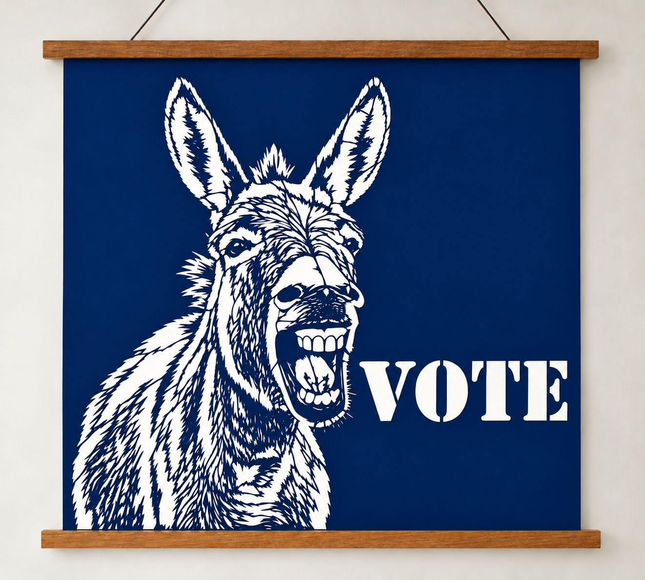 Dark blue political donkey VOTE poster featuring Ruthie, a handmade cut paper artwork displayed with a wooden magnetic hanger.