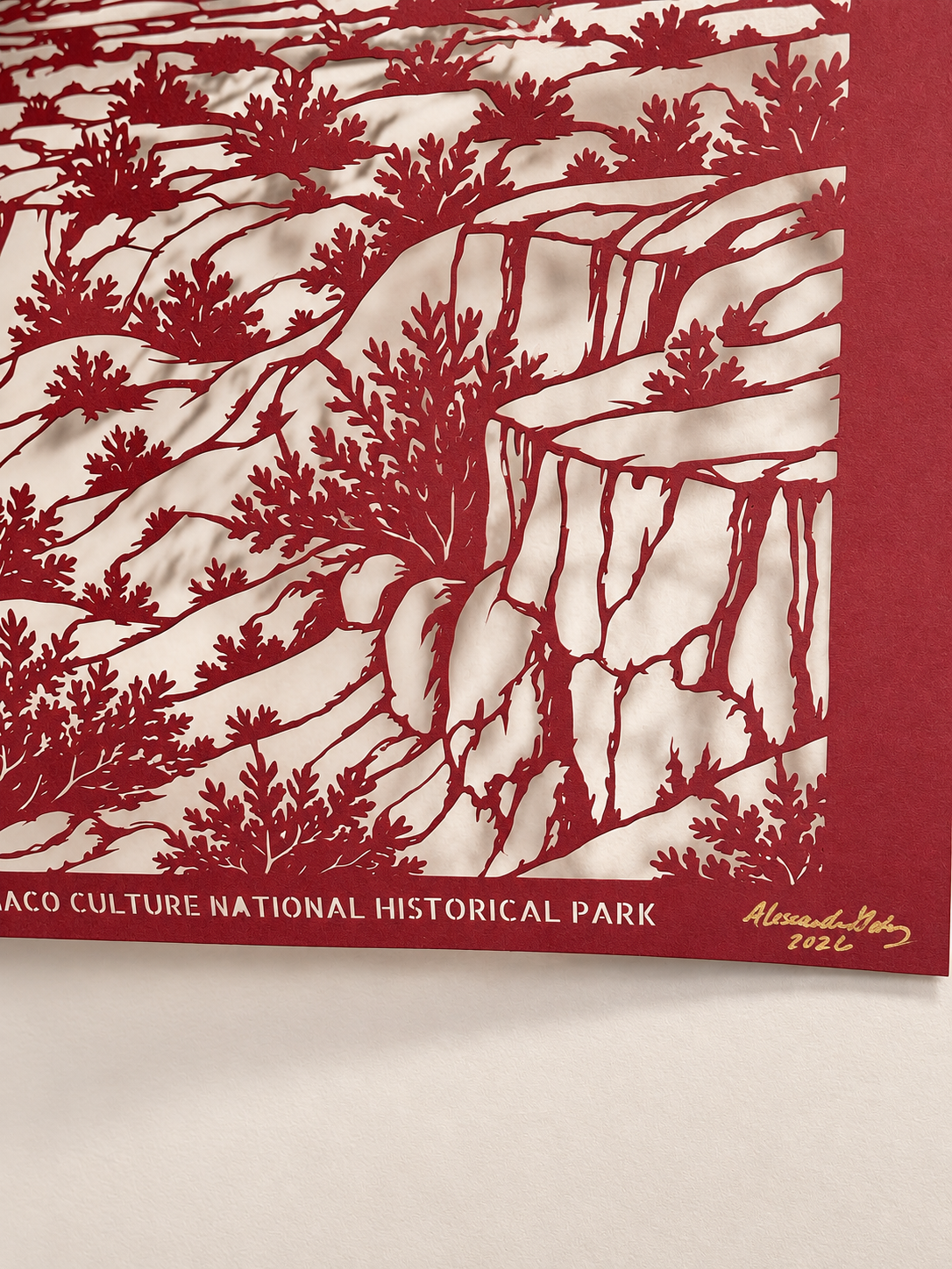 Close-up of intricately cut desert vegetation and canyon cliffs in Chaco Canyon paper artwork from the Endangered Landscapes series.