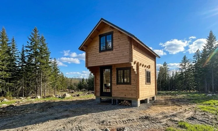 The STACK is our featured cabin for a reason.

11&times;11 log-style bunkie with a sleeping loft above. 

What makes it different is the wall system &mdash; interlocking tongue-and-groove solid pine planks instead of standard stud framing. Compact, s