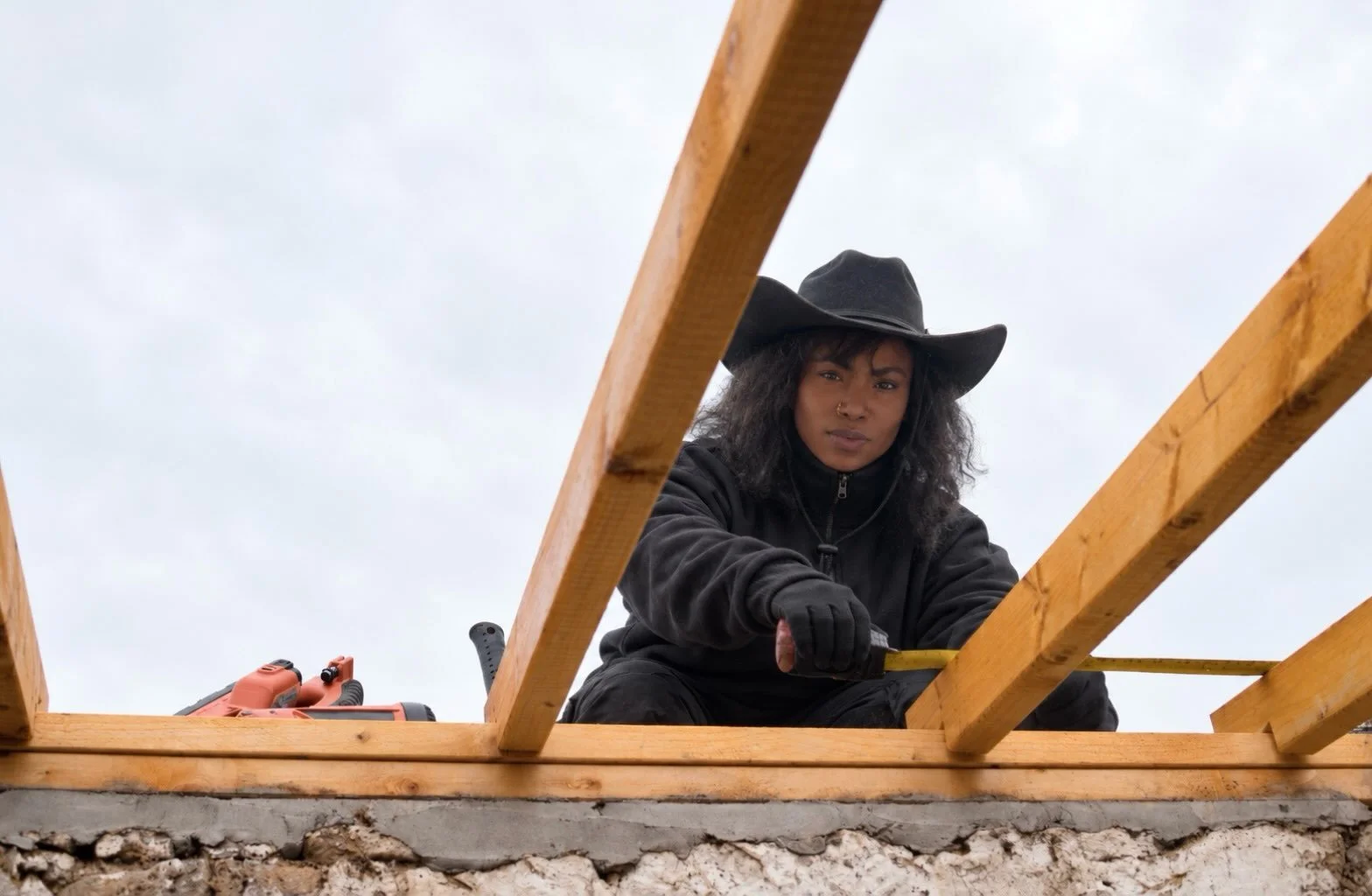 Ashley is testing the kit on a rainy day, the same way a client might have to: following the instructions step by step and checking every measurement before anything gets fastened.

Rain doesn&rsquo;t stop a build, but it does slow you down. Framing 