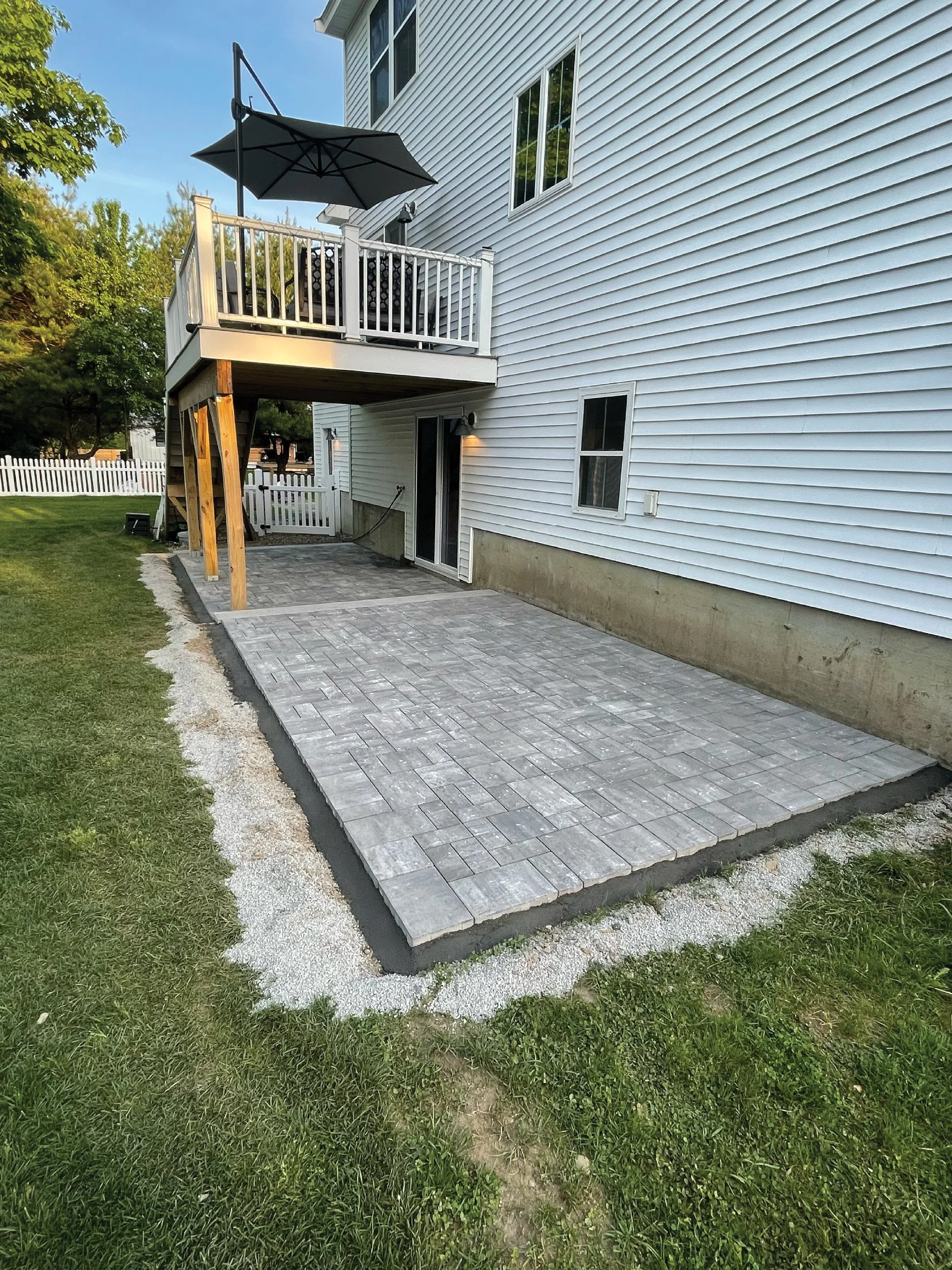 Two-tier limestone and granite backyard patio hardscape built by The Englishmen Masonry in Portsmouth, NH