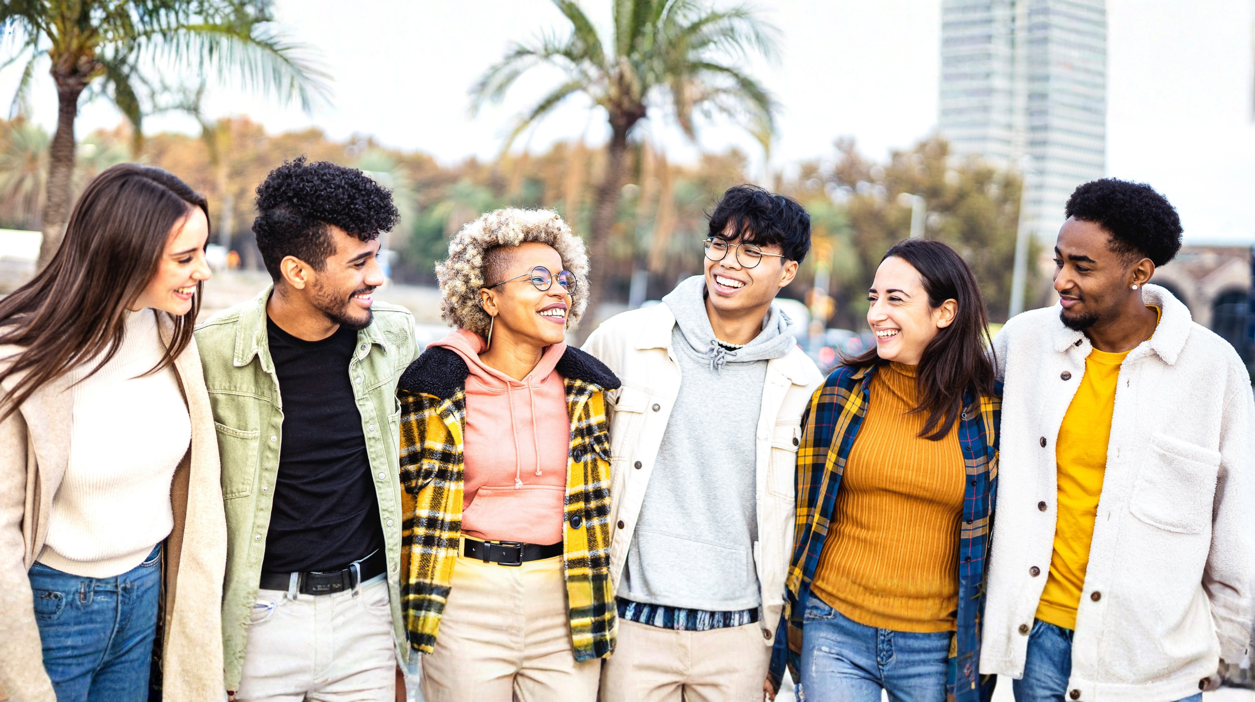 A group of friends hugging and smiling.
