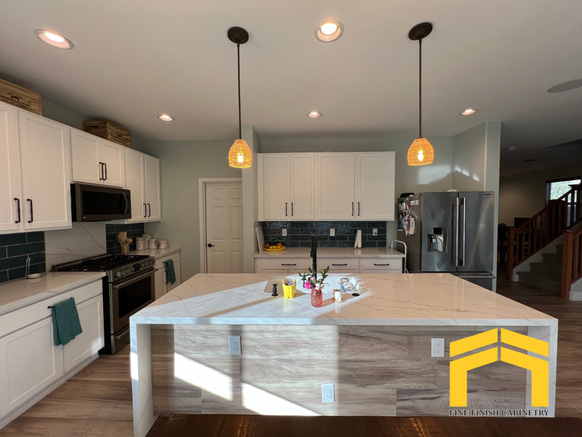 White kitchen cabinet refacing in Mesa Arizona featuring custom cabinets and a large waterfall island by Fine Finish Cabinetry