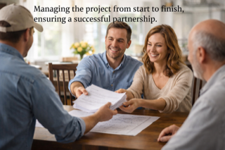 A woman and two men sitting at a table during a business meeting, with one man handing documents to the woman. The background shows a bright room with flowers on a table.
