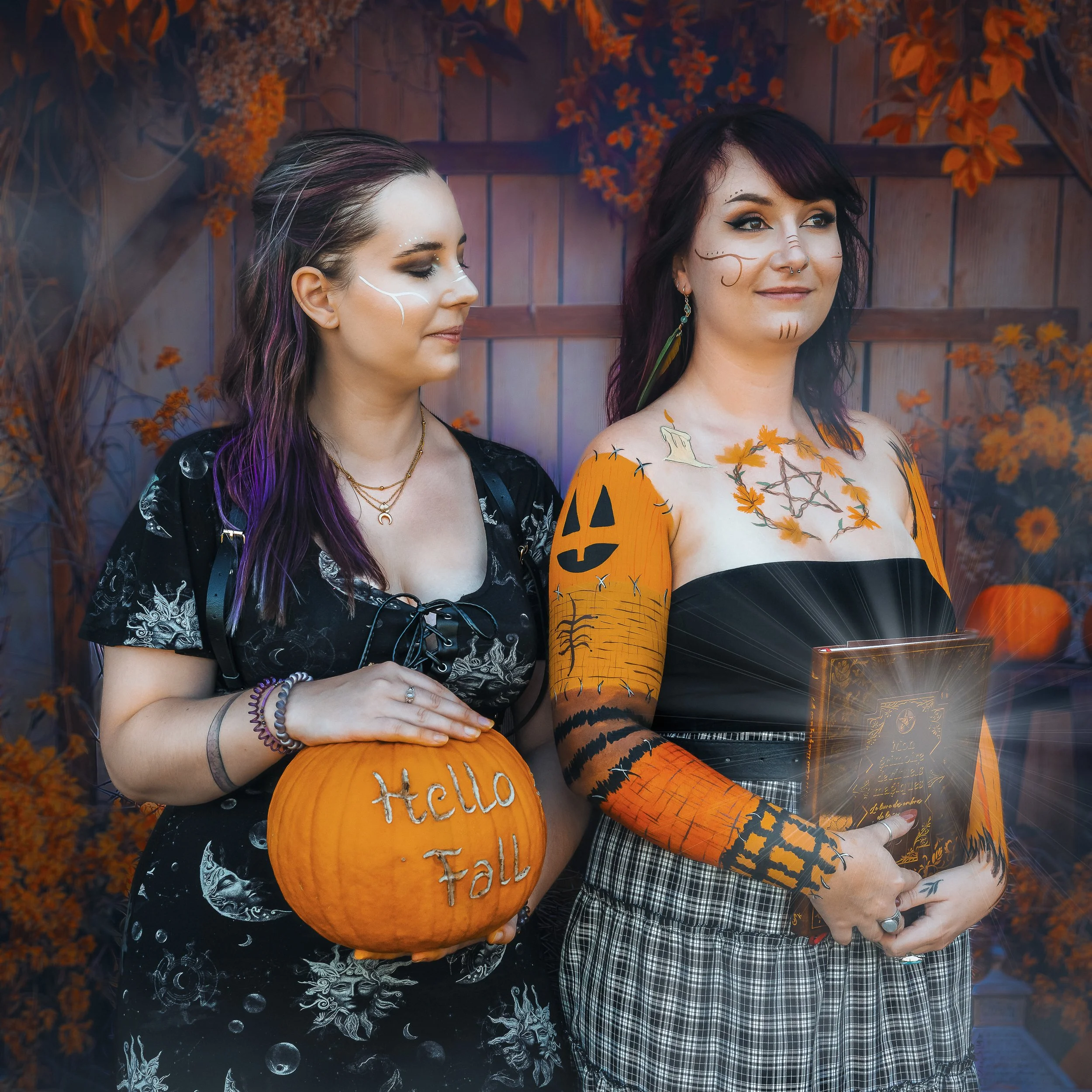 Deux femmes déguisées en Halloween, une d'elles tient une citrouille avec l'inscription « Hello Fall » et l'autre tient un livre, dans un décor orange et noir avec des feuilles d'automne.