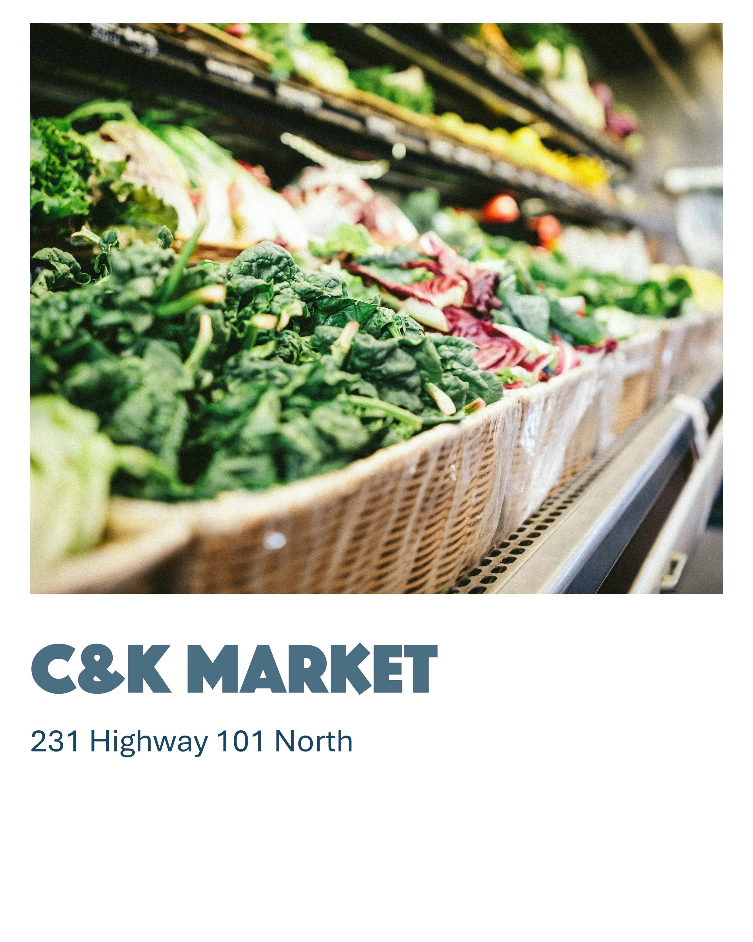 Fresh leafy greens and vegetables in a grocery store display.