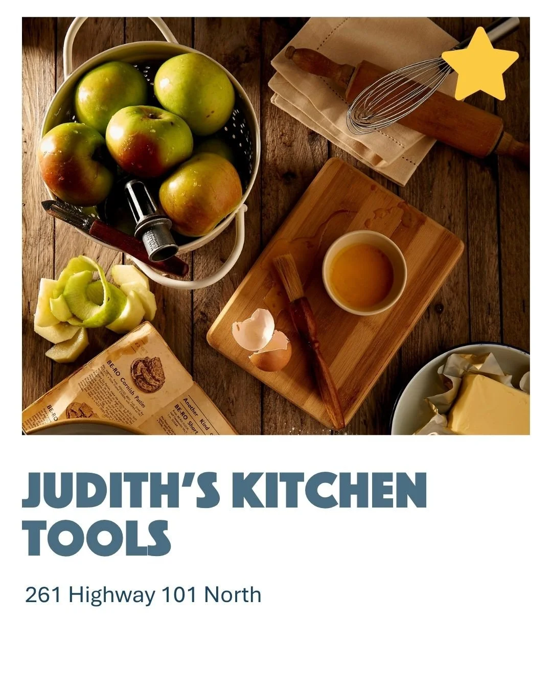 A top-down view of a kitchen countertop with apples, a lemon, a butter wrapper, a wooden rolling pin, a whisk, a small bowl of oil, a wooden cutting board, and a butter dish.