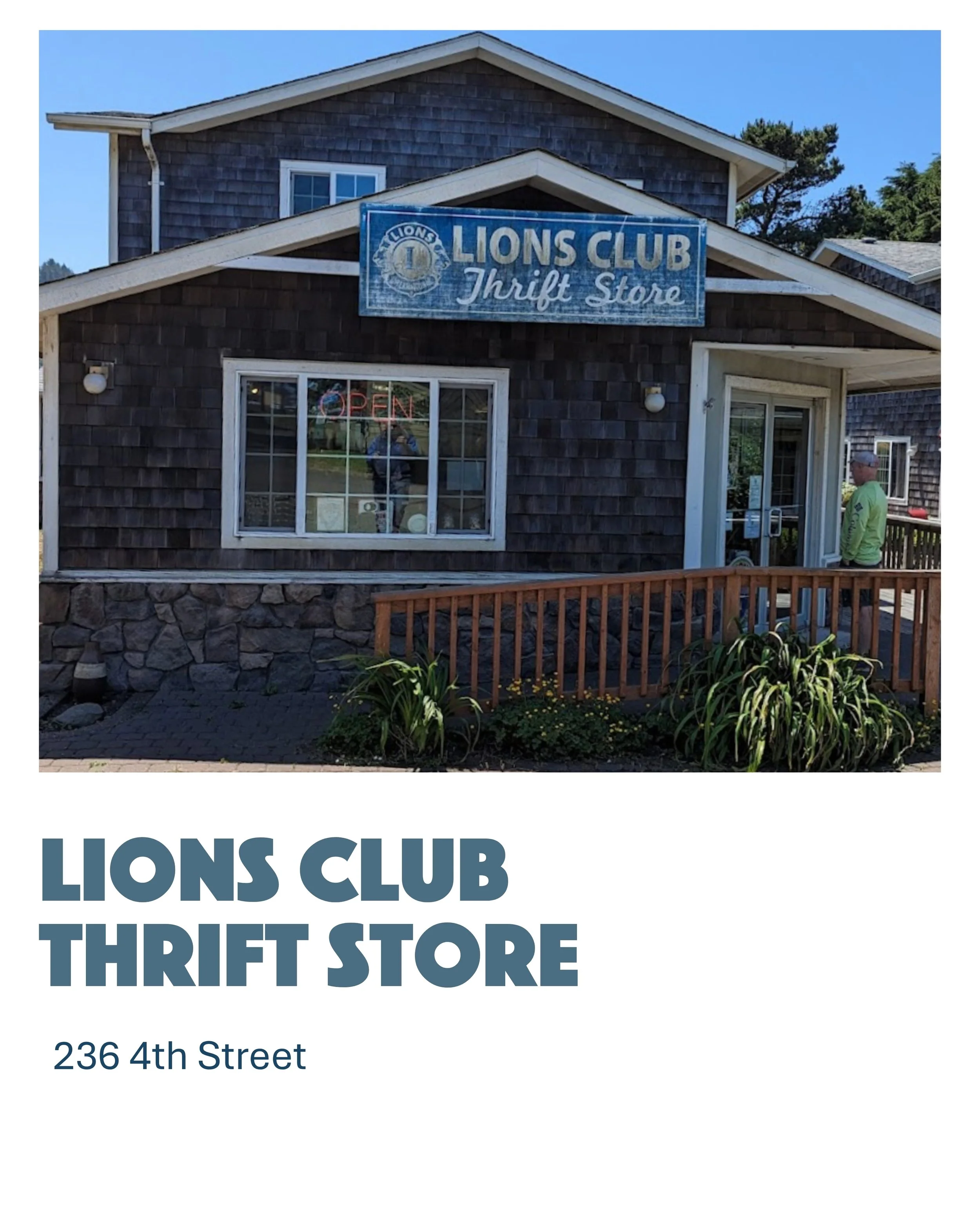 Exterior of a thrift store building with a sign that reads: 'Lions Club Thrift Store'. The building has dark wooden shingles, a stone foundation, and a small wooden ramp. A man in a green shirt and hat stands near the entrance. A neon sign in the window reads 'Open'.