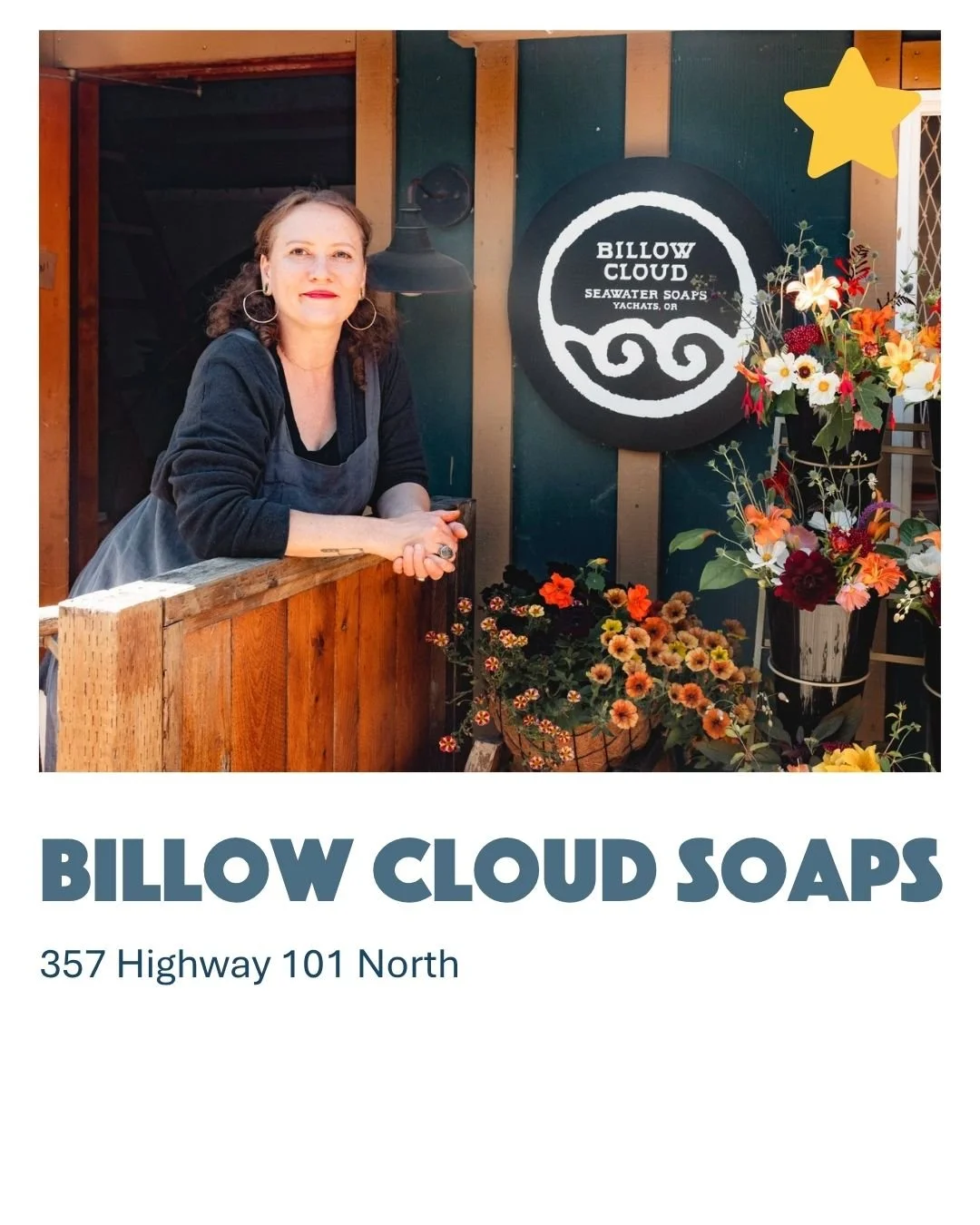 A woman in a black shirt and apron leaning on a wooden railing in front of a sign that reads "Billow Cloud Seawater Soaps," with colorful flowers on display nearby.