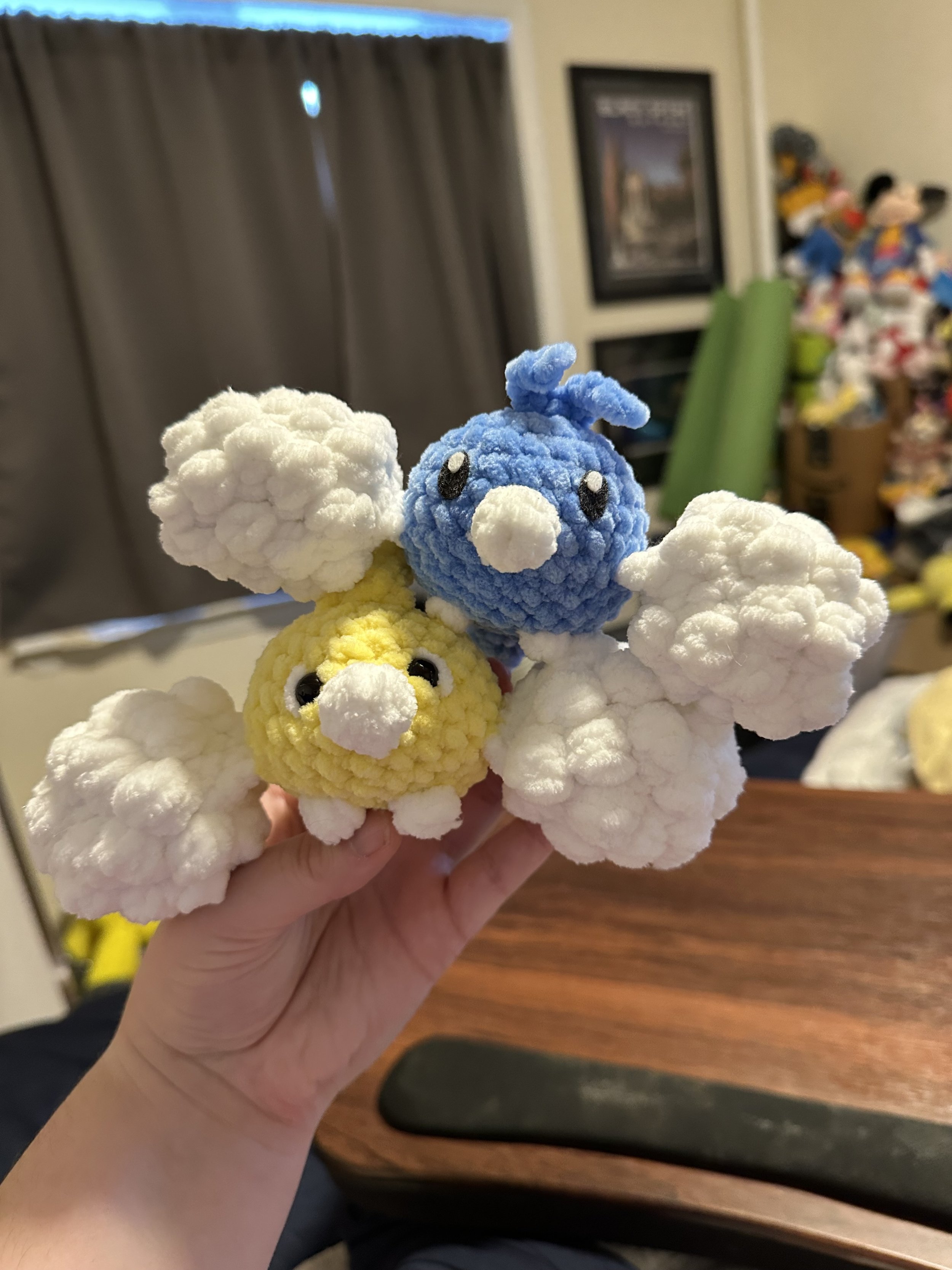 Two crochet birds with wings that look like clouds