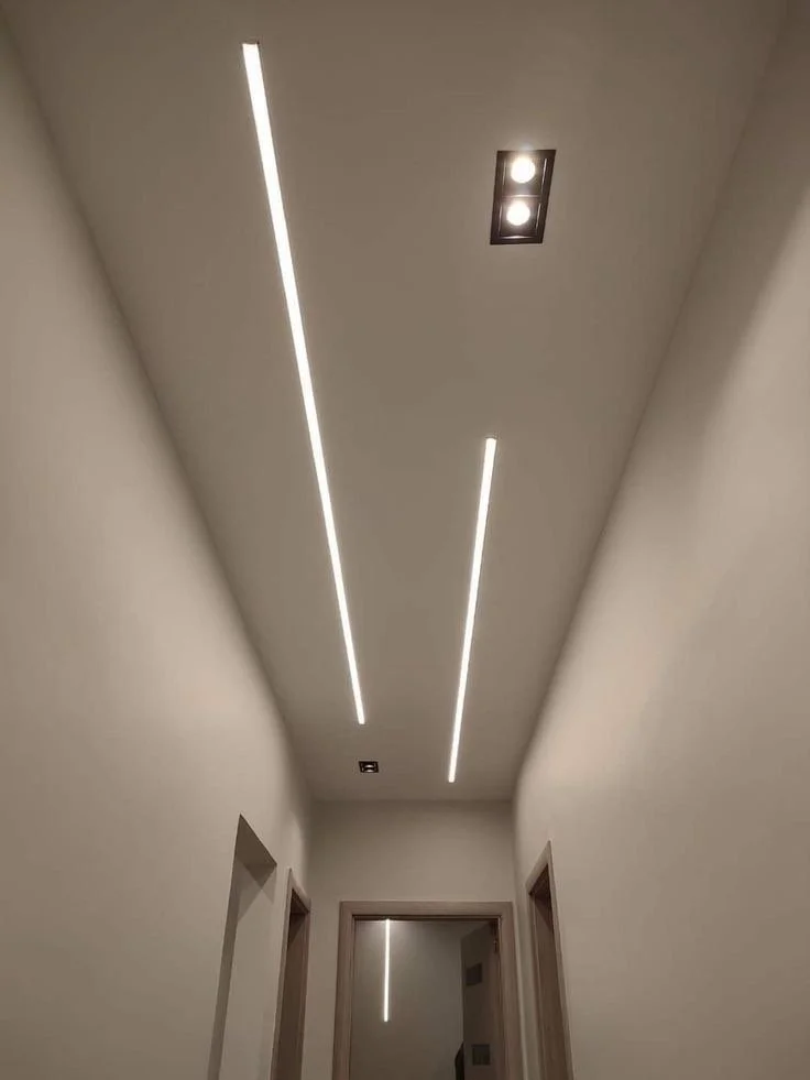 Gypsum ceiling with integrated LED profile lighting in a corridor of a home
