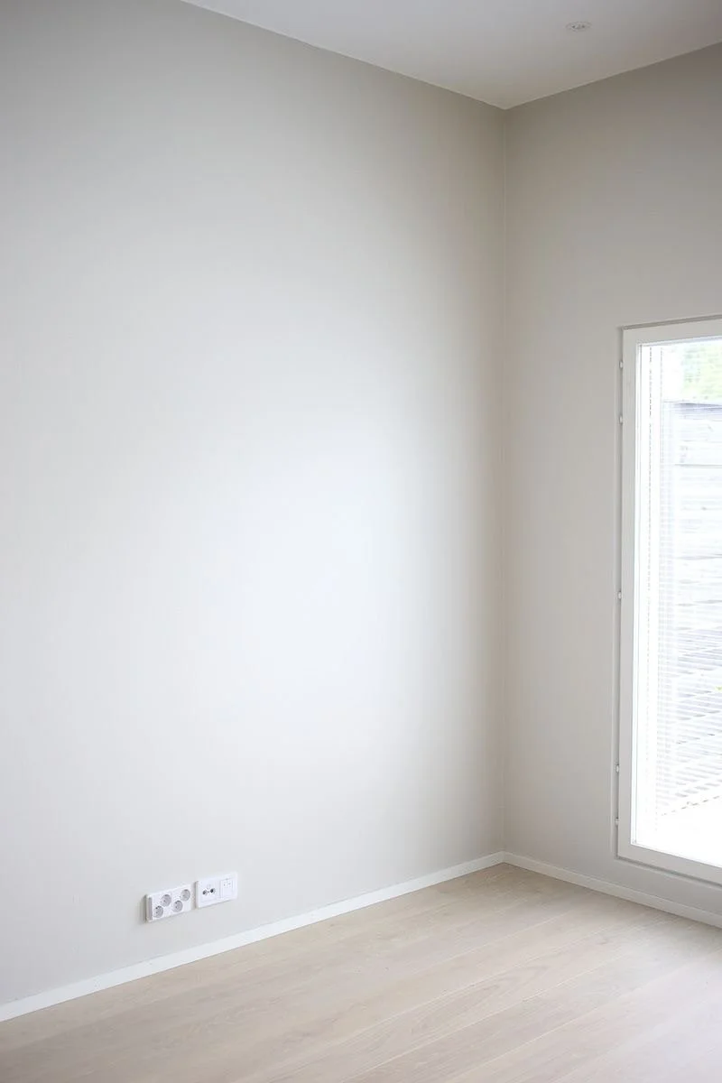 Soft cool-toned paint colour in a bedroom designed for comfort and relaxation