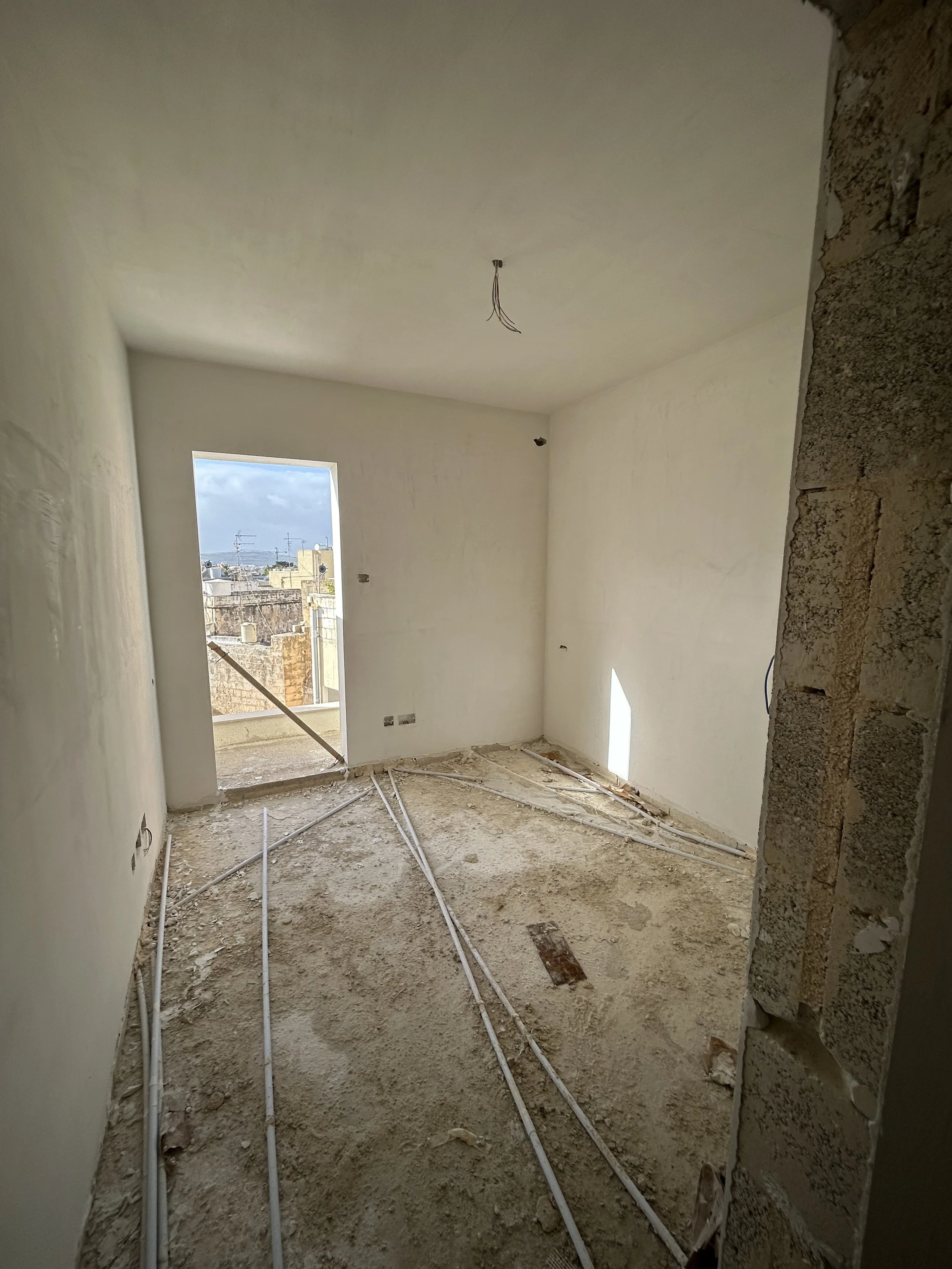 Room plastered using gibs and finitura for a smooth interior surface.