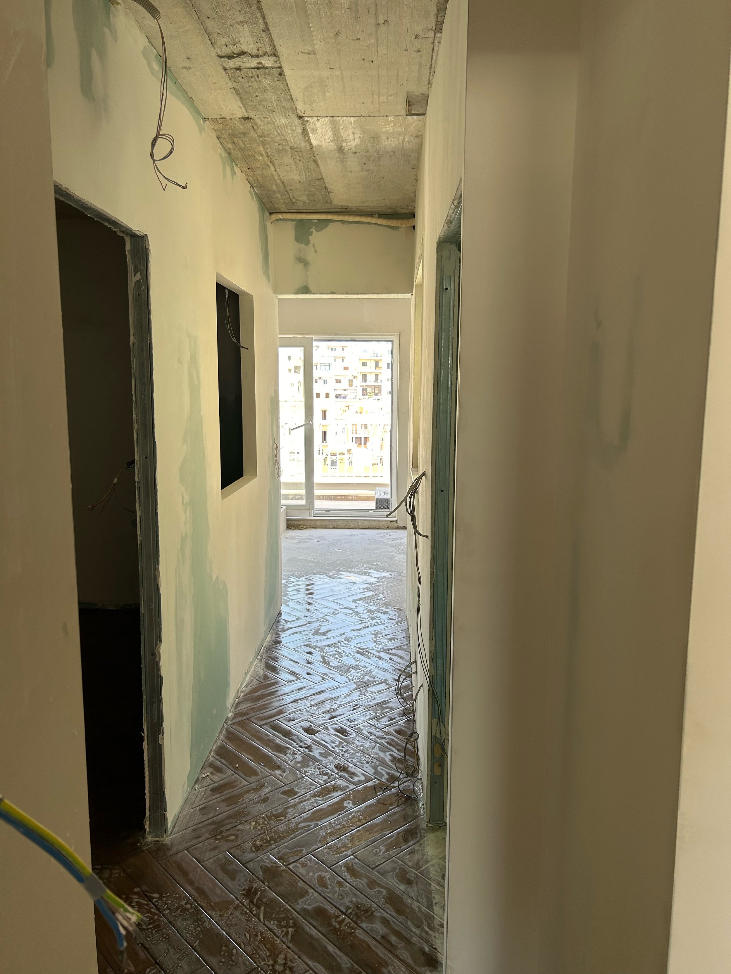 Gypsum partition walls dividing one large space into two rooms.