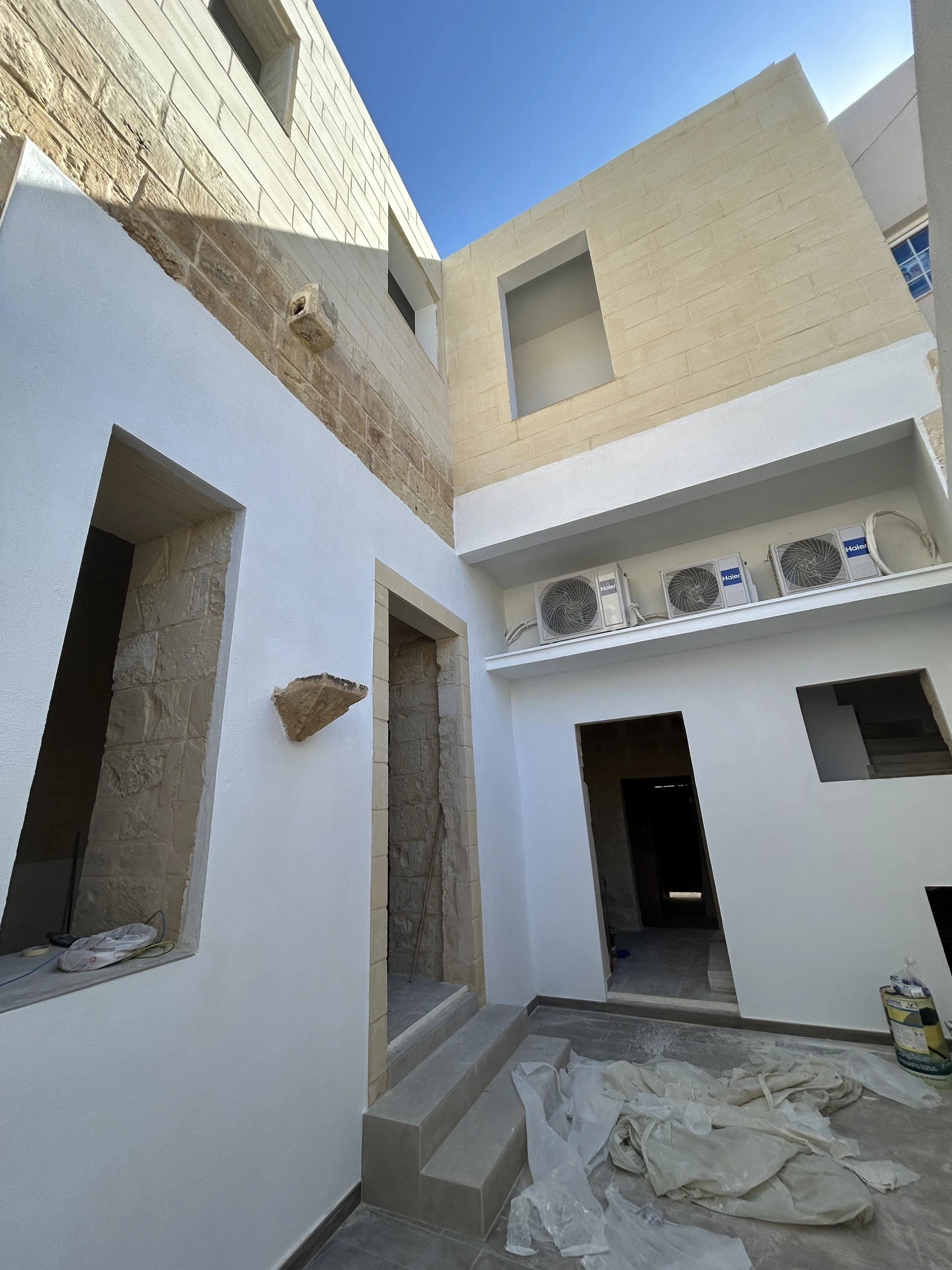 Outdoor yard plastered with GR1000 and painted in bright white.